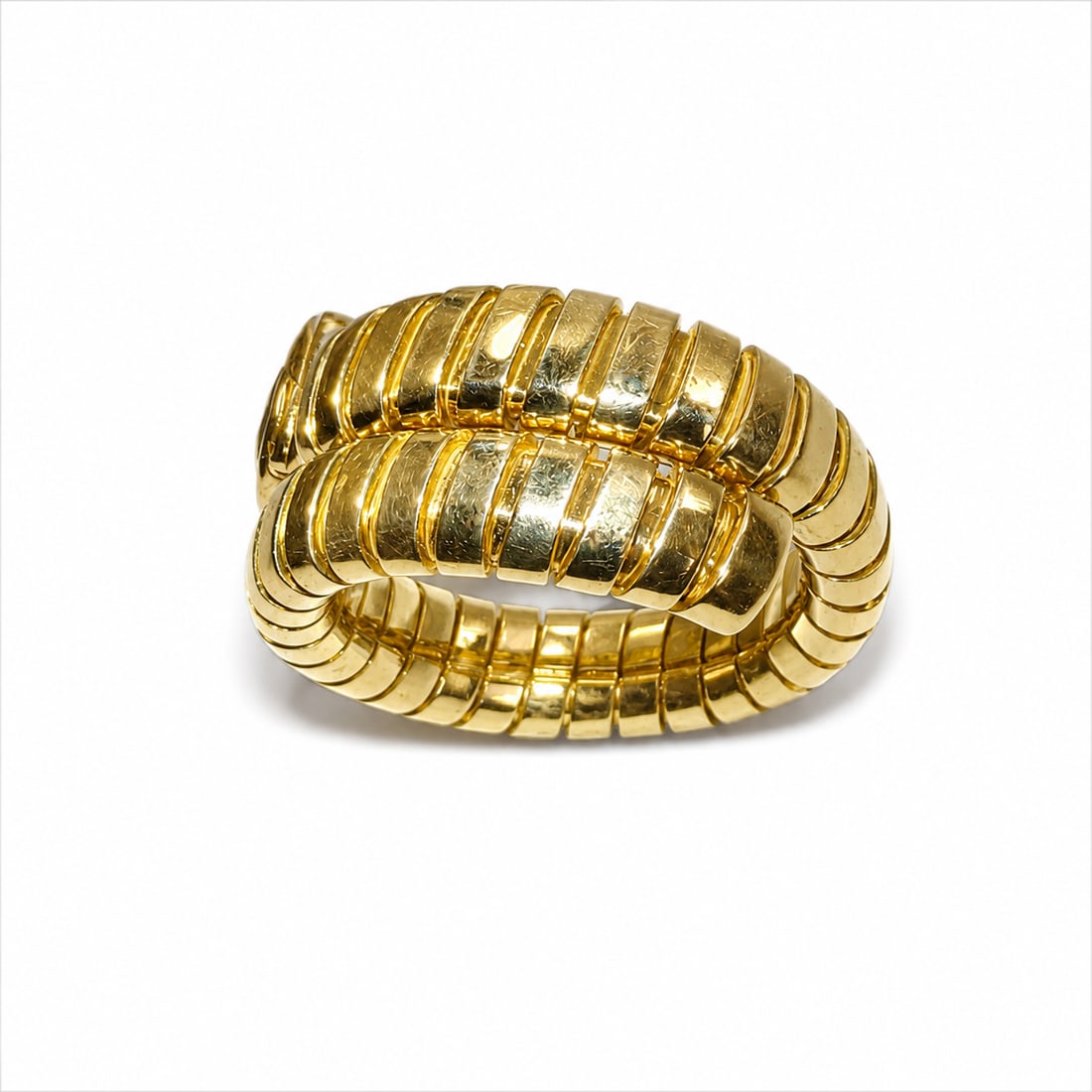BULGARI TUBOGAS SERPENTINI TOURMALINE RING: BULGARI TUBOGAS SERPENTINI TOURMALINE RING,10.5 grams, 18 ct. gold.Rich and vibrant tourmaline.Signed Bvlgari.Stretchable tubogas link, smallest size K 1/2
