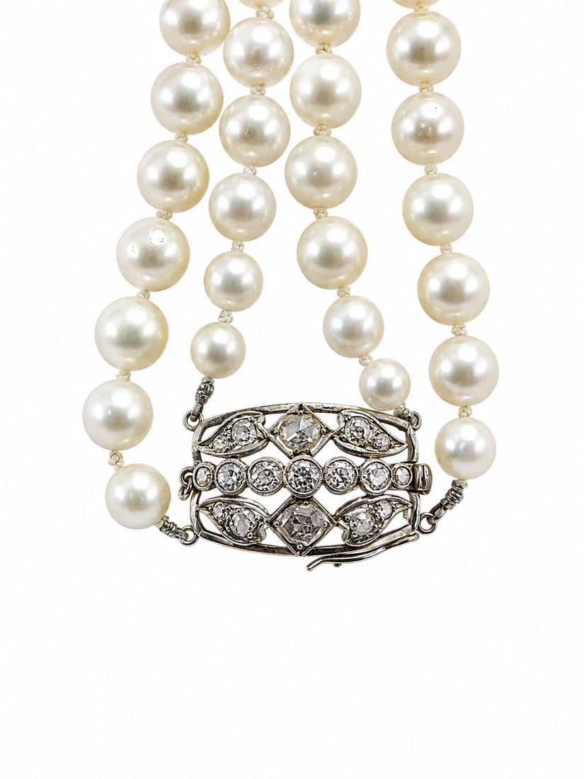 DOUBLE ROW PEARL AND DIAMOND NECKLACE: DOUBLE ROW PEARL AND DIAMOND NECKLACE,98.6 grams.Largest pearl of approx. 8.9 mm. (pearls untested).The clasp set with old and rose cut diamonds.L. necklace 51 cm.