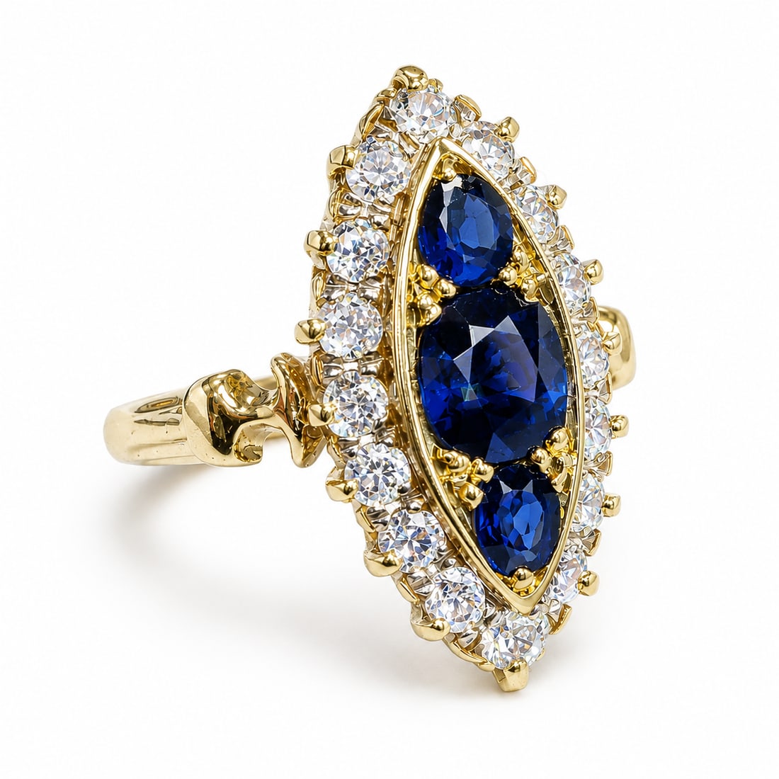 SAPPHIRE AND DIAMOND MARQUISE SHAPED RING: SAPPHIRE AND DIAMOND MARQUISE SHAPED RING,5,6 grams, testing 18 ct. gold.Rich and vibrant sapphires totalling approx. 1.30 ct.Diamonds bright and lively.Size N.