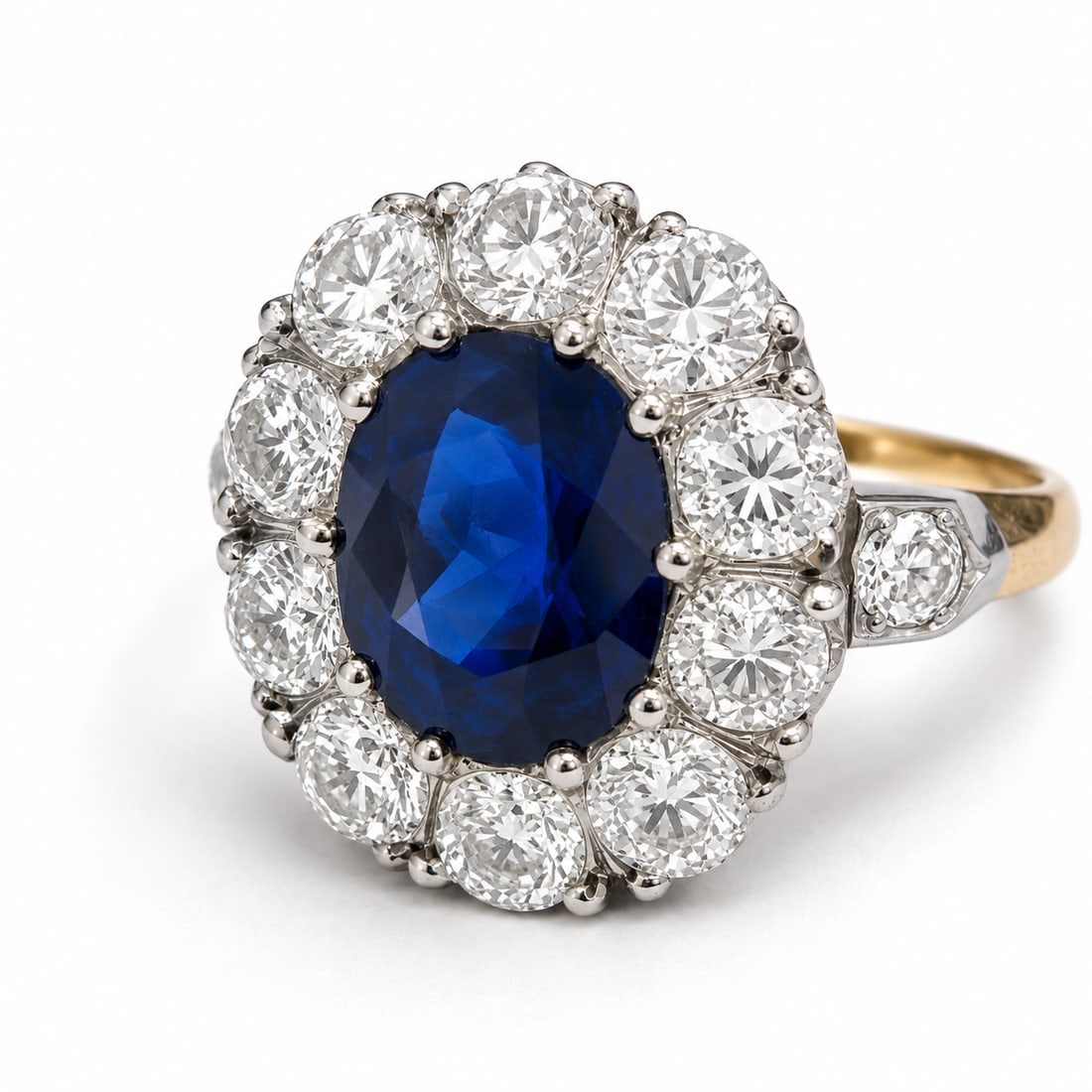 SAPPHIRE AND DIAMOND CLUSTER RING: SAPPHIRE AND DIAMOND CLUSTER RING,5,1 grams, testing 18 ct. gold.Rich and vibrant sapphire of approx. 3.10 ct.Bright and lively old cut diamonds, totalling approx. 2 ct.Size M 1/2.