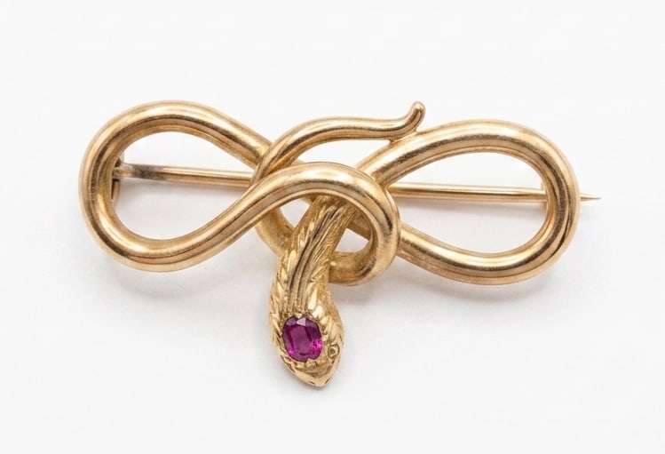 VICTORIAN PINK SAPPHIRE SNAKE BROOCH: VICTORIAN PINK SAPPHIRE SNAKE BROOCH,4.8 grams, testing high carat gold.Lovely pink sapphire.W. 3.4 cm.