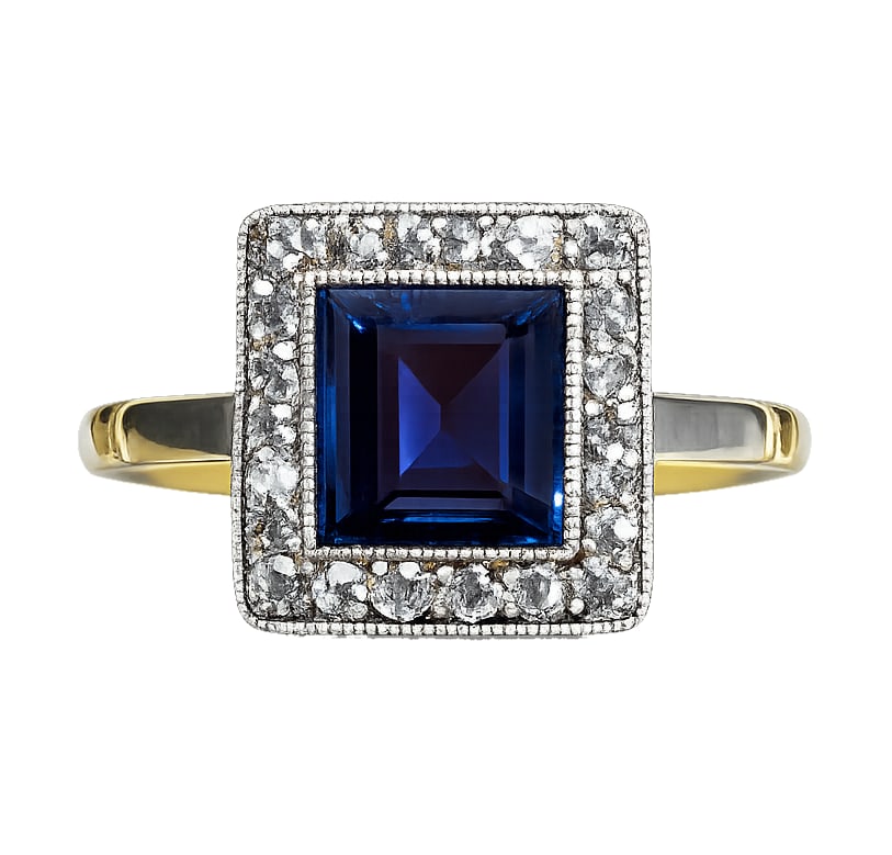 SAPPHIRE AND DIAMOND CLUSTER RING: SAPPHIRE AND DIAMOND CLUSTER RING,3,2 grams, testing 18 ct. gold and platinum.Rich and vibrant sapphire of approx. 1.35 ct.Diamonds bright and lively.Size N.