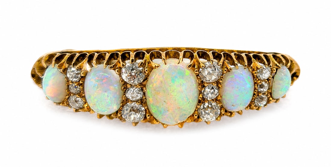 OPAL AND DIAMOND BROOCH: OPAL AND DIAMOND BROOCH,5,1 grams, testing 18 ct. gold.Rich and vibrant opals with good play of colour including red.Diamonds bright and lively.L. 3.6 cm.