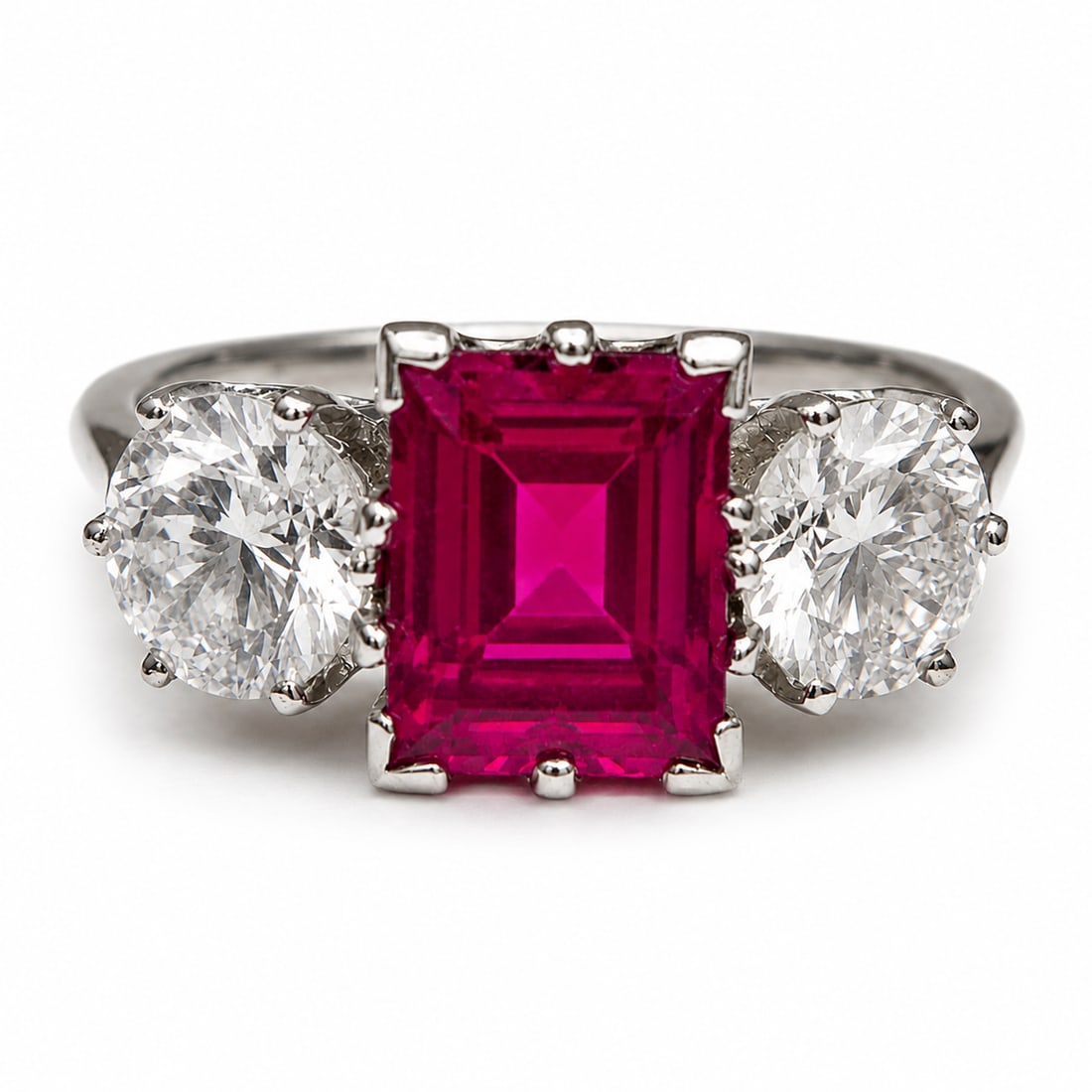 RUBY AND DIAMOND 3-STONE RING: RUBY AND DIAMOND 3-STONE RING,3,5 grams, testing 18 ct. gold.Rich and vibrant ruby of approx. 1.47 ct.Bright and lively diamonds, totalling approx. 1.05 ct.Size L 1/2.