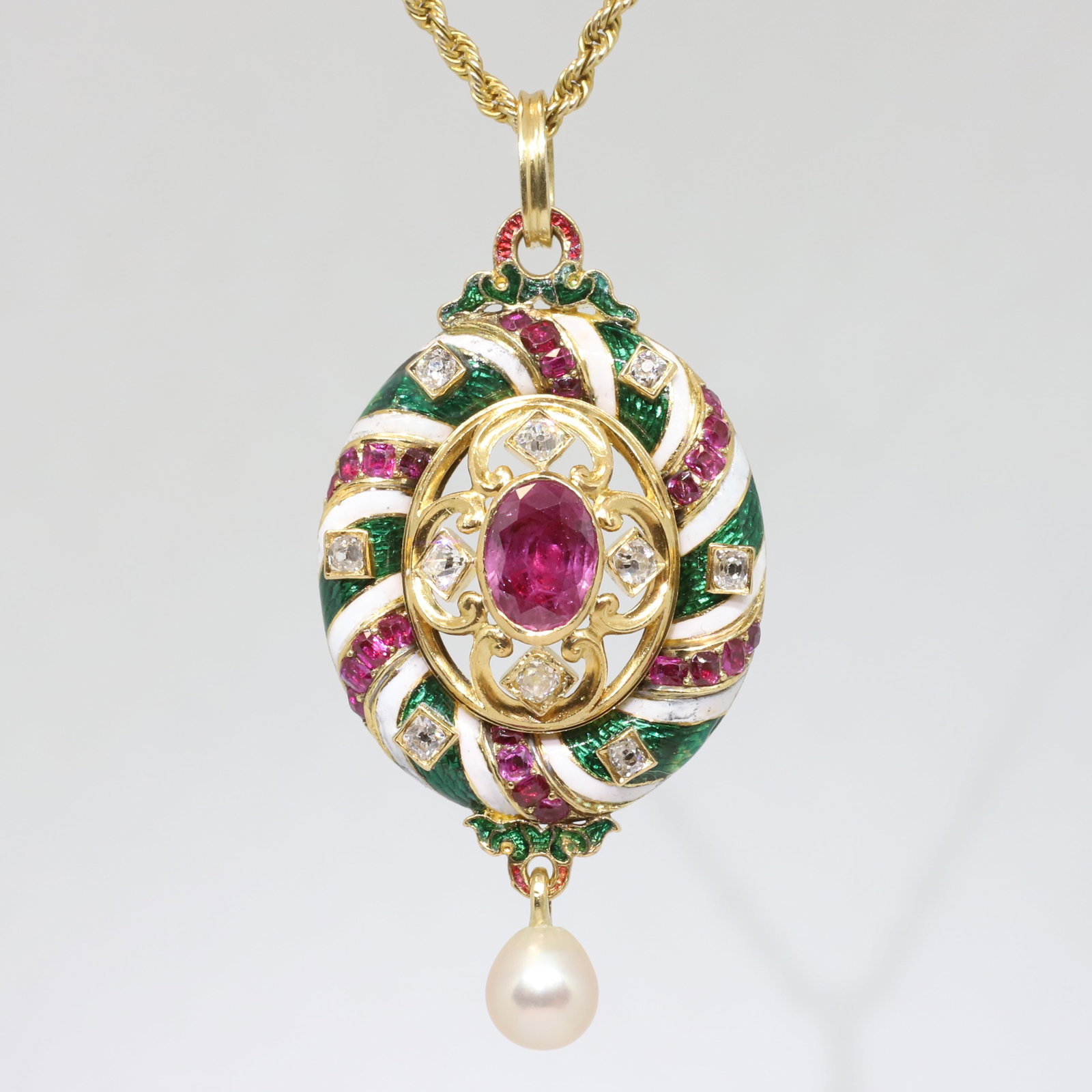 FINE HOLBEINESQUE RUBY, DIAMOND, PEARL AND ENAMEL PENDANT: FINE HOLBEINESQUE RUBY, DIAMOND, PEARL AND ENAMEL PENDANT,19.4 grams, testing high carat gold.The pendant set with a central ruby.Further accnetualed with rubies and bright and lively diamonds, on a
