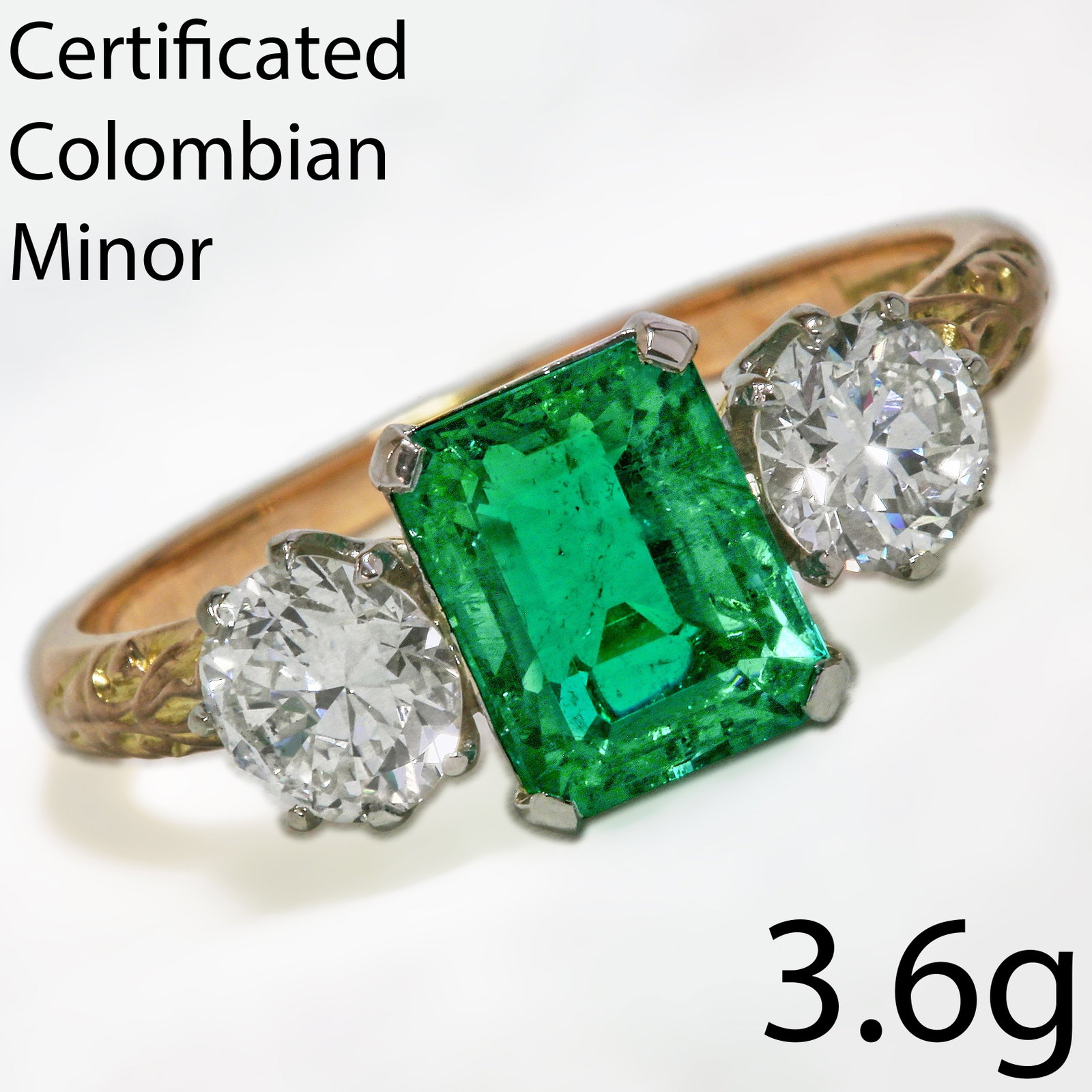 IMPORTANT CERTIFICATED COLOMBIAN EMERALD AND DIAMOND THREE STONE RING: IMPORTANT CERTIFICATED COLOMBIAN EMERALD AND DIAMOND THREE STONE RING 3.6 grams high carat gold rich vibrant colombian emerald, with no abrasions colmbian minor, approx 1.81 ct bright lively