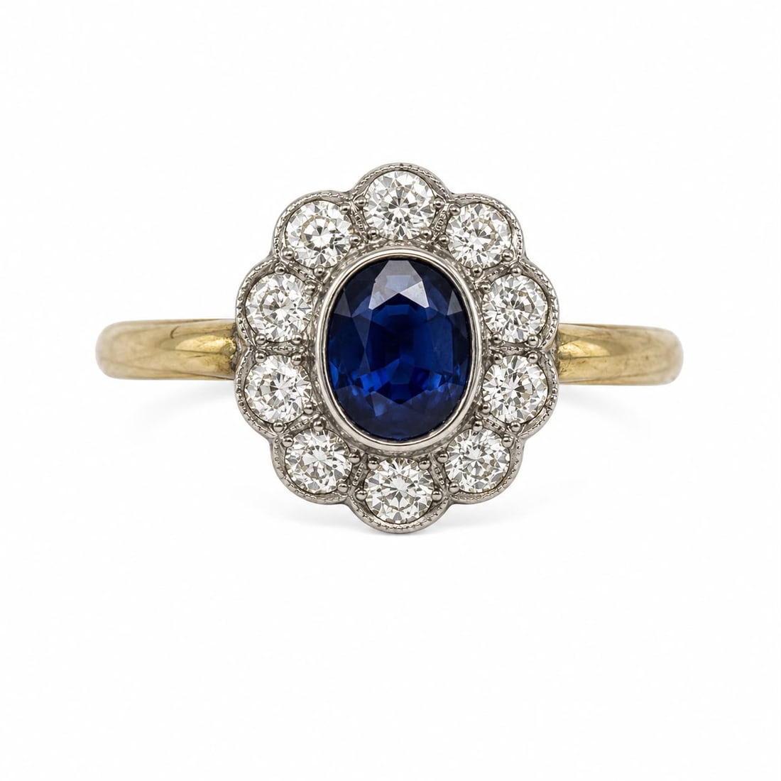 SAPPHIRE AND DIAMOND CLUSTER RING: SAPPHIRE AND DIAMOND CLUSTER RING,4,4 grams, testing 18 ct. gold.Rich and vibrant sapphire of approx. 1.70 ct.Diamonds bright and lively.Size N.