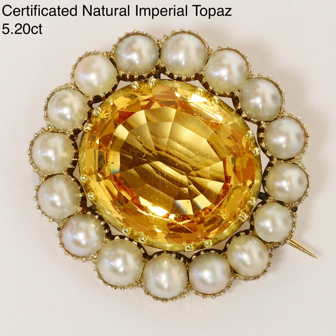CERTIFICATED IMPERIAL TOPAZ AND PEARL BROOCH: CERTIFICATED IMPERIAL TOPAZ AND PEARL BROOCH,4,6 grams, testing high carat gold.Rich and vibrant imperial topaz of 5.20 ct. (Certificated, no treatment).Fine pearls (untested, assumed to be natural).W