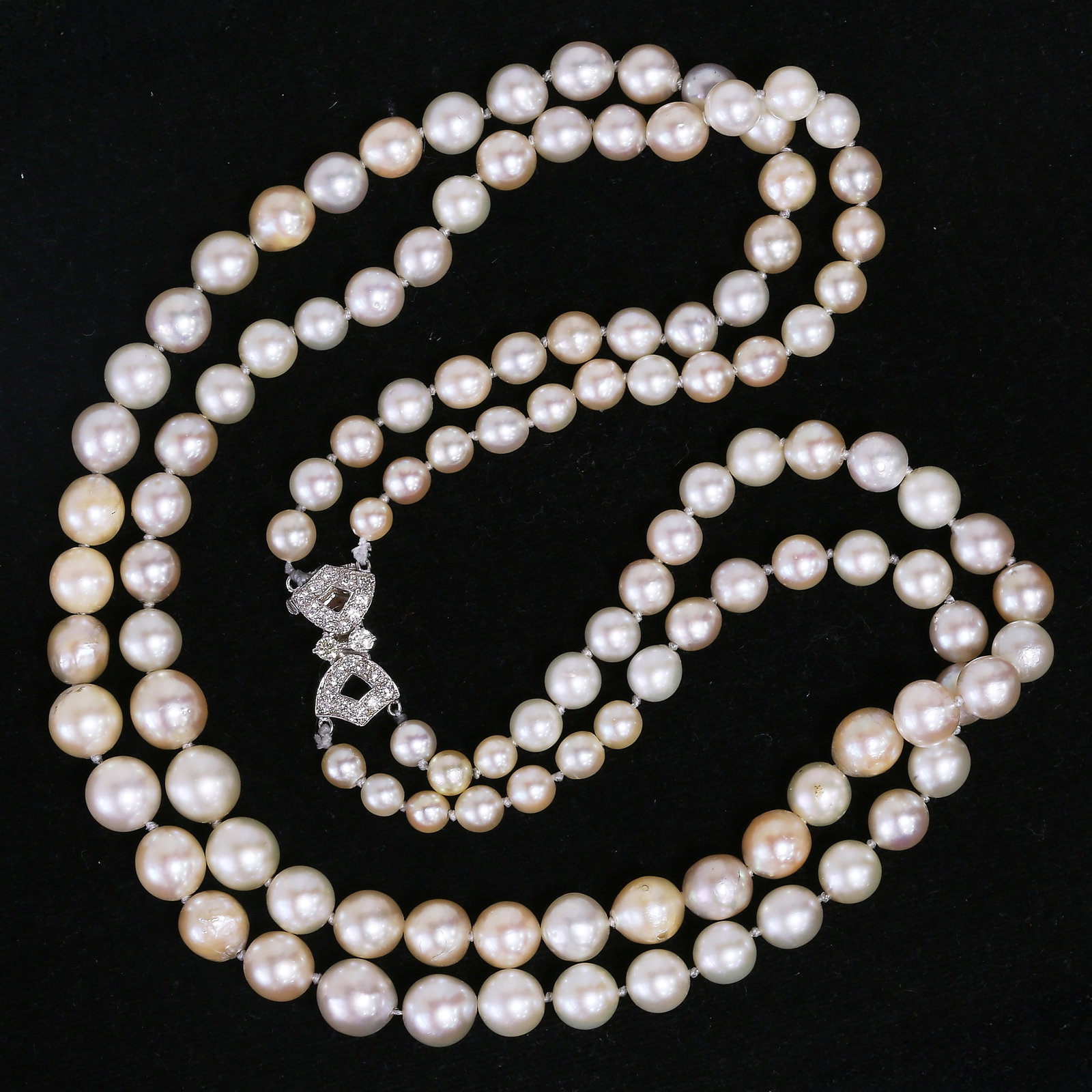 TWO STRAND PEARL NECKLACE WITH DIAMOND CLASP: TWO STRAND PEARL NECKLACE WITH DIAMOND CLASP 55.7 grams 18 ct gold diamond clasp pearls well matched (untested).L 42 cm