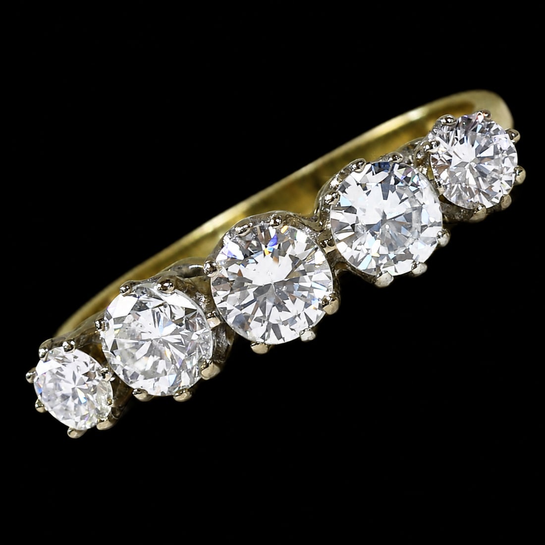 DIAMOND 5-STONE RING: DIAMOND 5-STONE RING,3.6 grams, 18 ct. gold.Diamonds bright and lively, totalling approx. 1..55 ct.Size O 1/2.