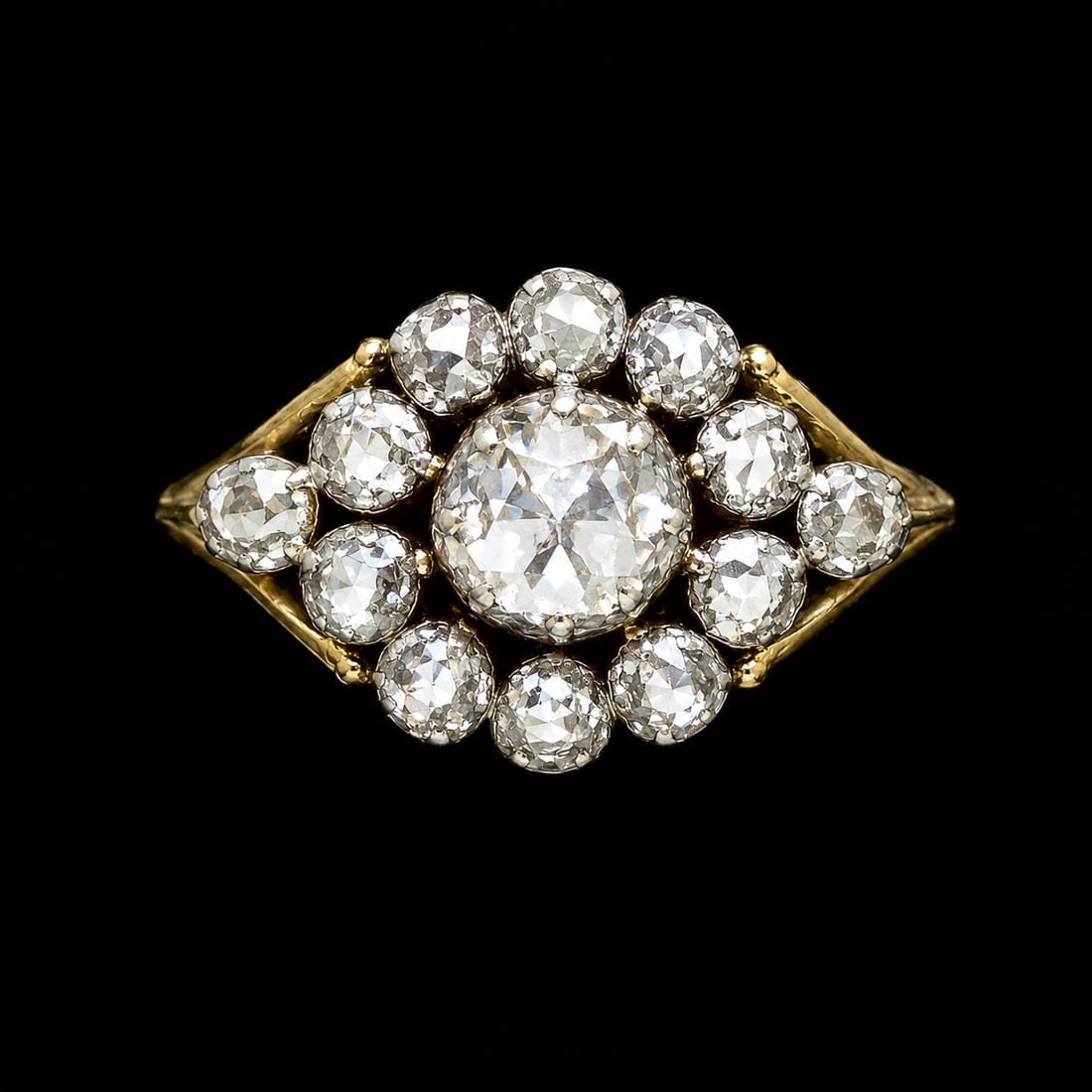 ANTIQUE DIAMOND CLUSTER RING: ANTIQUE DIAMOND CLUSTER RING,8.2 grams, testing 18 ct. gold.Bright and lively diamonds, with a larger central diamond.Size N.