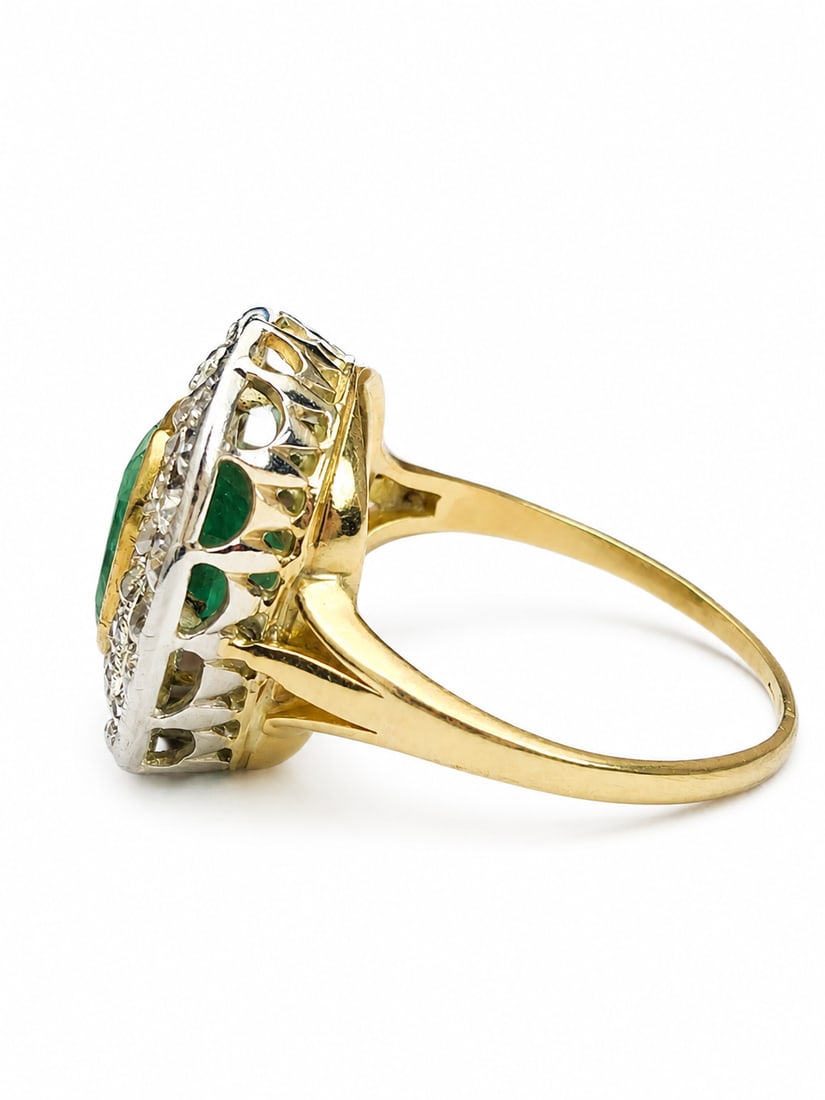 EMERALD AND DIAMOND CLUSTER RING: EMERALD AND DIAMOND CLUSTER RING,3,7 grams, testing 18 ct. gold and platinum.Rich and vibrant emerald of approx. 1.80 ct.Diamonds bright and lively in a double halo cluster.Size M.