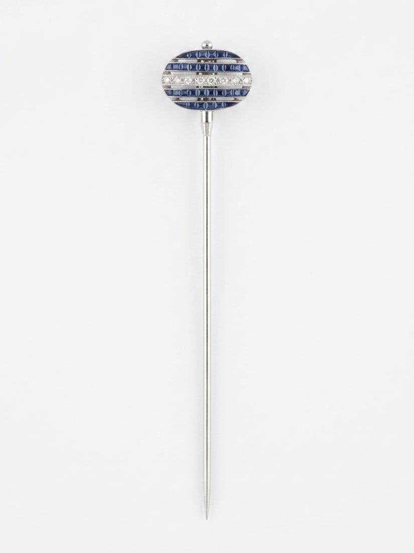 CARTIER, AN ART DECO SAPPHIRE AND DIAMOND DOUBLE SIDED STICK PIN: CARTIER, AN ART DECO SAPPHIRE AND DIAMOND DOUBLE SIDED STICK PIN 4.7 grams Pin marked Depose Cartier Paris, numberedopenwork panel of convertible, double-sided design, featuring rows of old-cut diamon