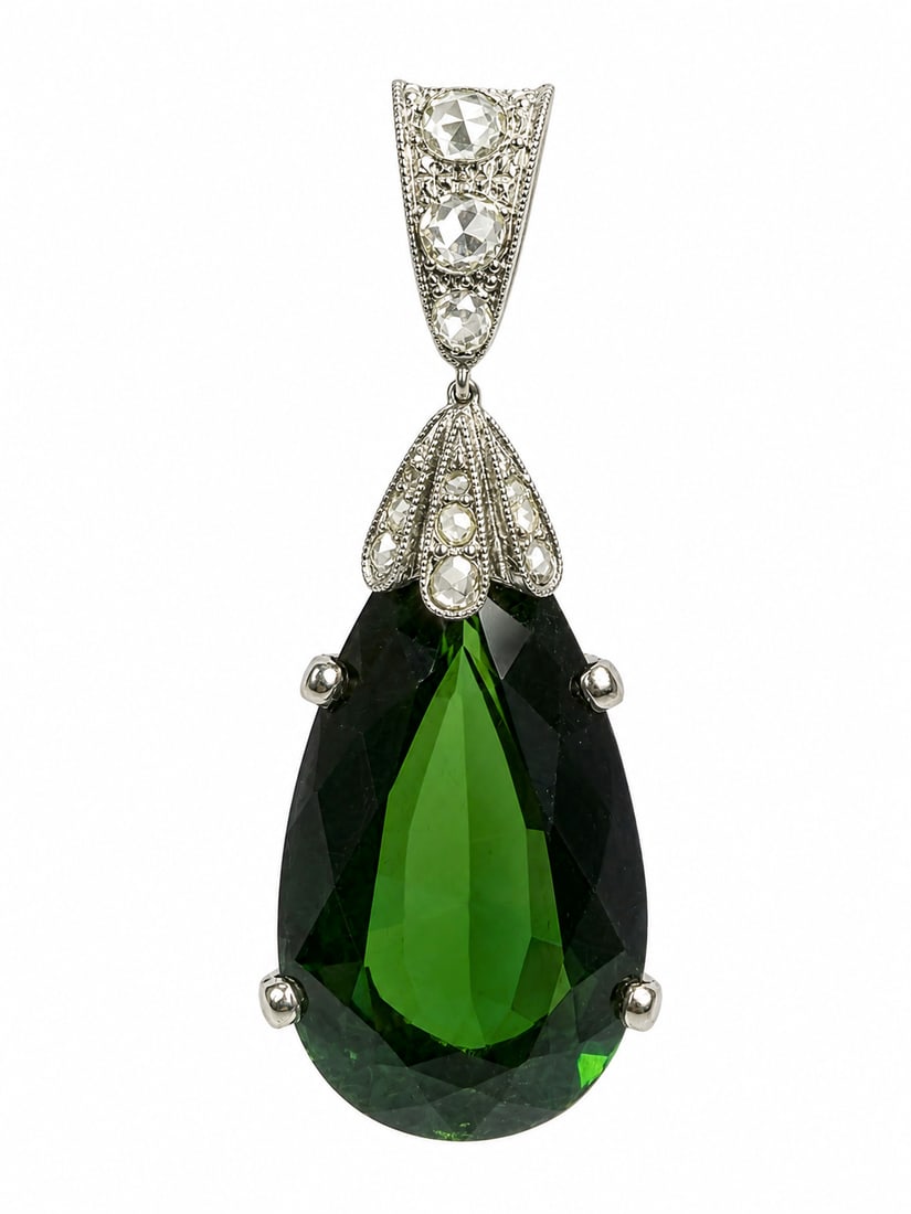 FINE TOURMALINE AND DIAMOND PENDANT: FINE TOURMALINE AND DIAMOND PENDANT,8..3 grams, testing high carat gold.Large pear shaped green tourmaline, of approx. 22.65 ct.Diamonds bright and lively.L. 4.6 cm.