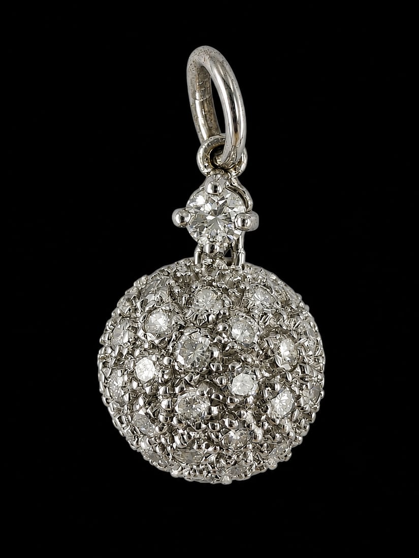 DIAMOND BALL PENDANT: DIAMOND BALL PENDANT,testing 18 ct. gold.Bright and lively diamonds.L. 1.9 cm.