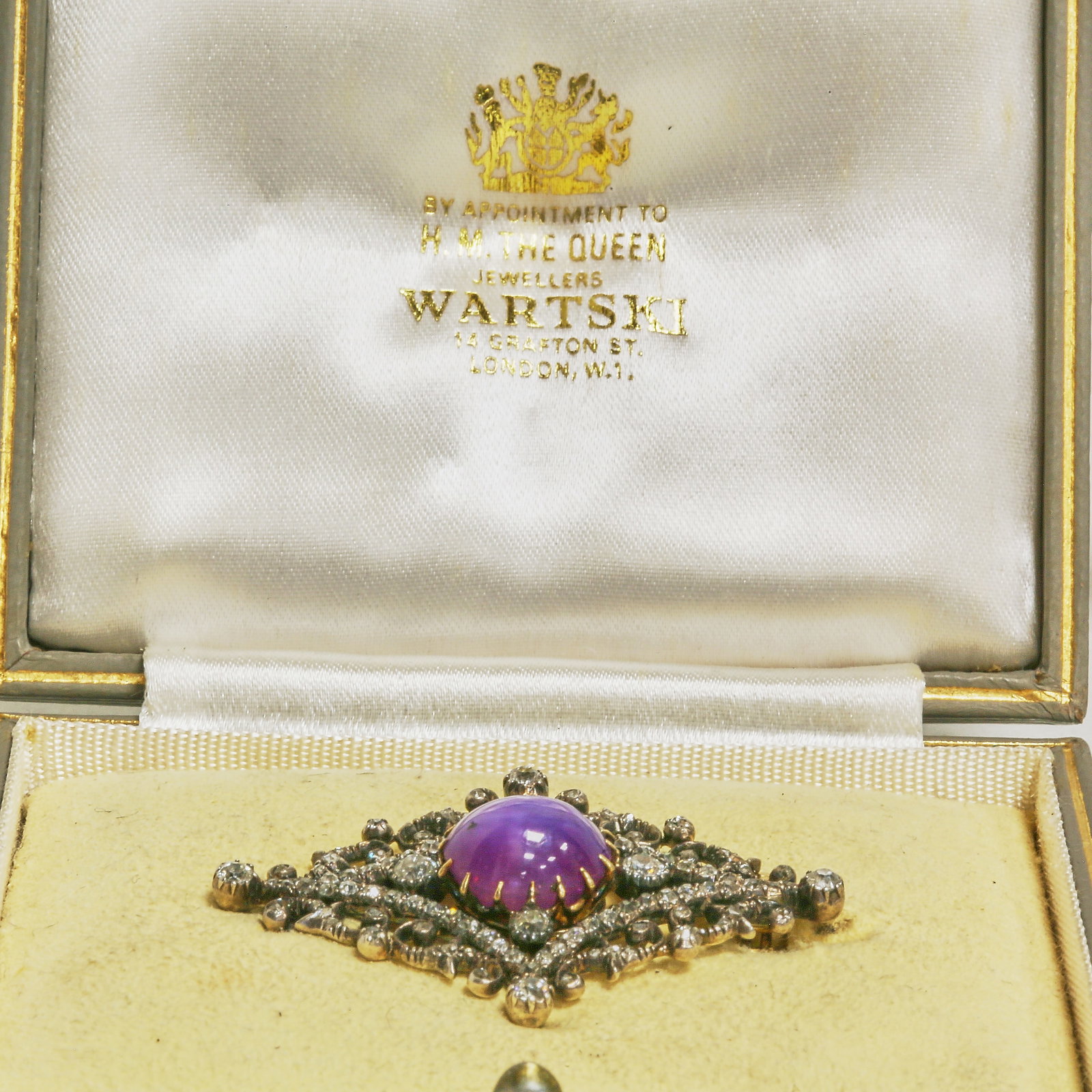 A MAGNIFICENT VICTORIAN CERTIFICATED PURPLE STAR SAPPHIRE AND DIAMOND BROOCH,: A MAGNIFICENT VICTORIAN CERTIFICATED PURPLE STAR SAPPHIRE AND DIAMOND BROOCH,11.3 grams.A magnificent Victorian brooch centering a certificated no-heat Ceylon purple star sapphire of approximately 10.