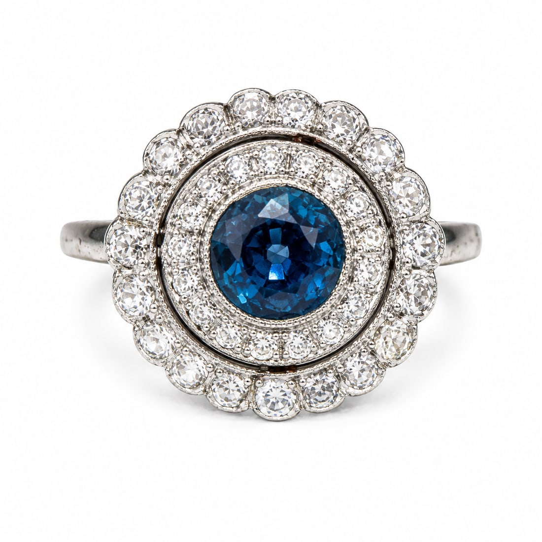 EDWARDIAN SAPPHIRE AND DIAMOND 'TARGET' CLUSTER RING,: EDWARDIAN SAPPHIRE AND DIAMOND 'TARGET' CLUSTER RING,testing platinum.Lovely sapphire of approx. 0.75 ct.Diamonds bright and lively.Size K 1/2.