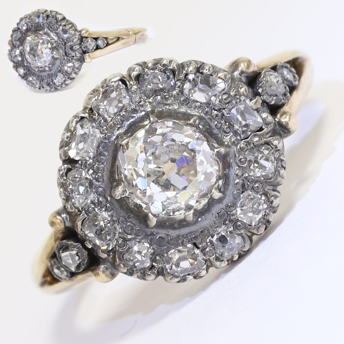 ANTIQUE DIAMOND CLUSTER RING,: ANTIQUE DIAMOND CLUSTER RING,4,9 grams. Fine target design.Lovely old cut central diamond of approx. 0.93 ct.Diamonds totalling approx. 1.35 ct.Size O.