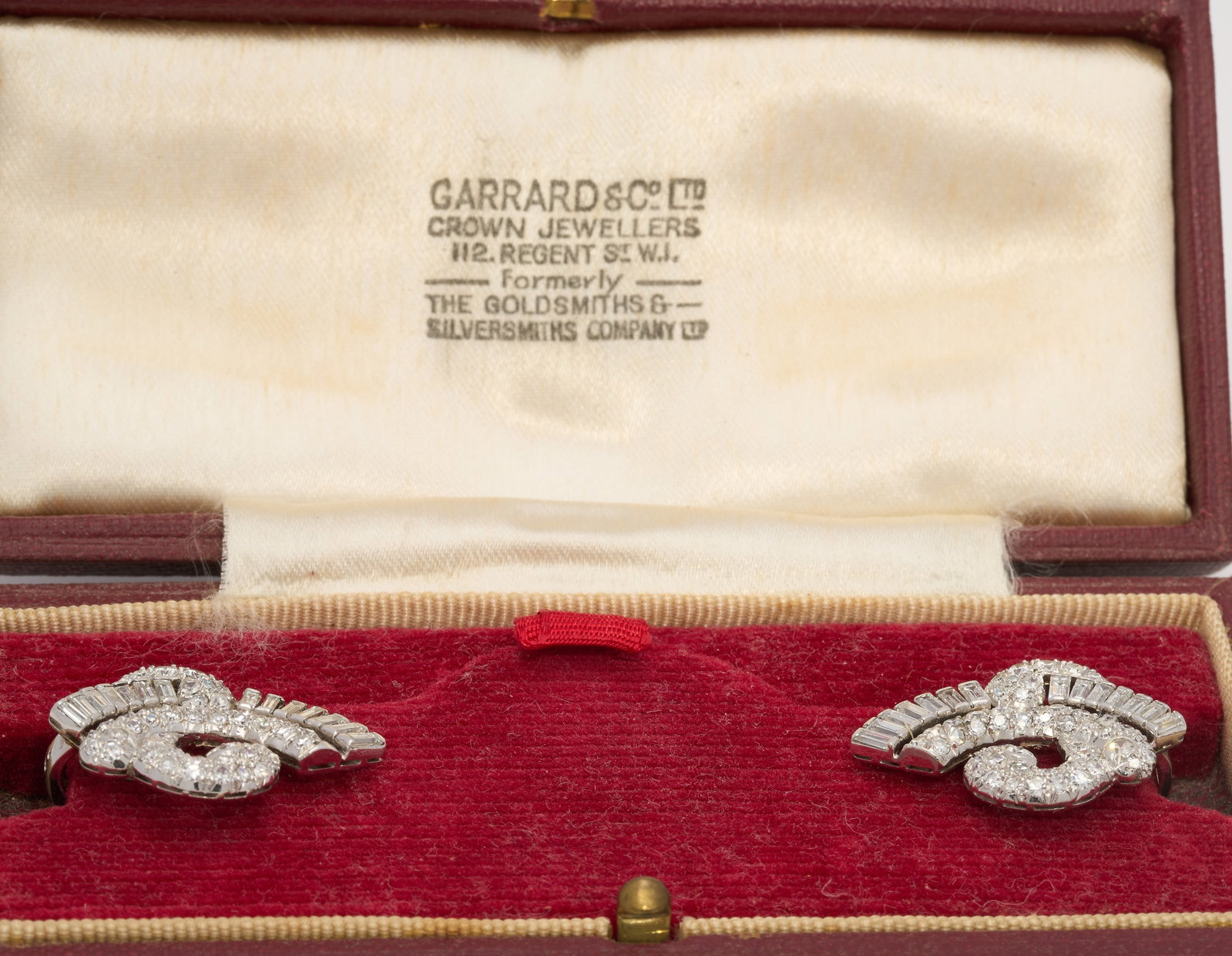 CARTIER PARIS, PAIR OF FANTASTIC ART-DECO DIAMOND EARRINGS,: CARTIER PARIS, PAIR OF FANTASTIC ART-DECO DIAMOND EARRINGS,11.9 grams, 18 ct. gold and platinum (French marked).The earrings of refined swirl design.Diamonds bright and lively, totalling approx. 2.50