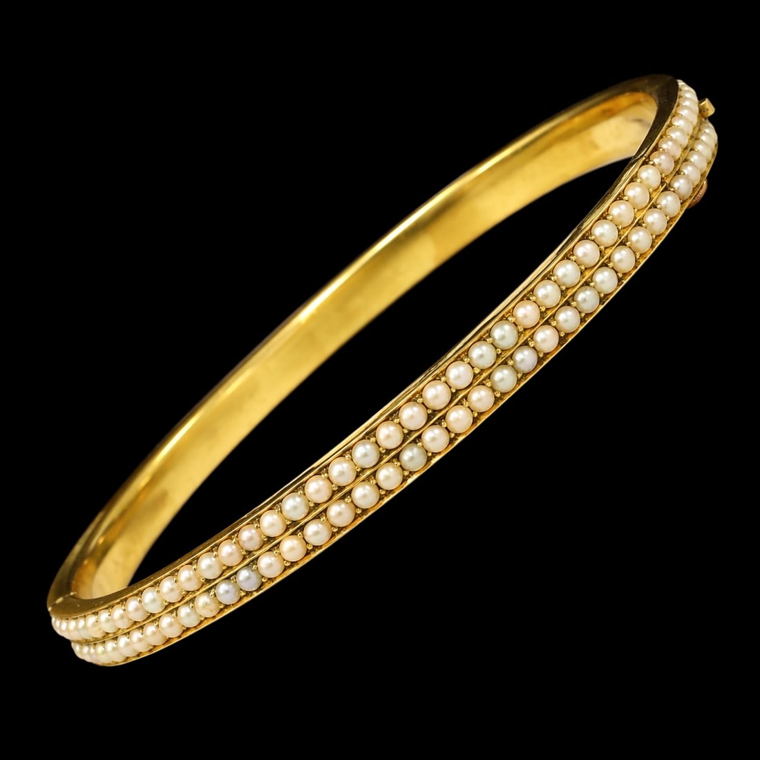 VICTORIAN DOUBLE ROW PEARL HINGED BANGLE,: VICTORIAN DOUBLE ROW PEARL HINGED BANGLE,12.9 grams, testing high carat gold.Pearls generally well matched.Inner diam. 6.1 cm.