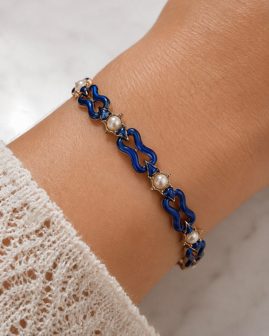 ANTIQUE ENAMEL AND PEARL BRACELET,: ANTIQUE ENAMEL AND PEARL BRACELET,23.6 grams, testing high carat gold.The links with fine blue enamel (in good condition).Alternated with pearl and diamond star sections.(pearls untested, believed to