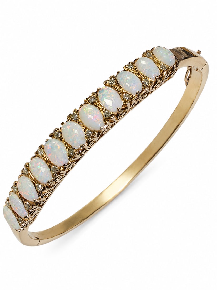 GOLD OPAL AND DIAMOND BANGLE.: GOLD OPAL AND DIAMOND BANGLE.20.1 gramsSet with opals of good play of colours.lively diamonds 5.8 cm inner diameter