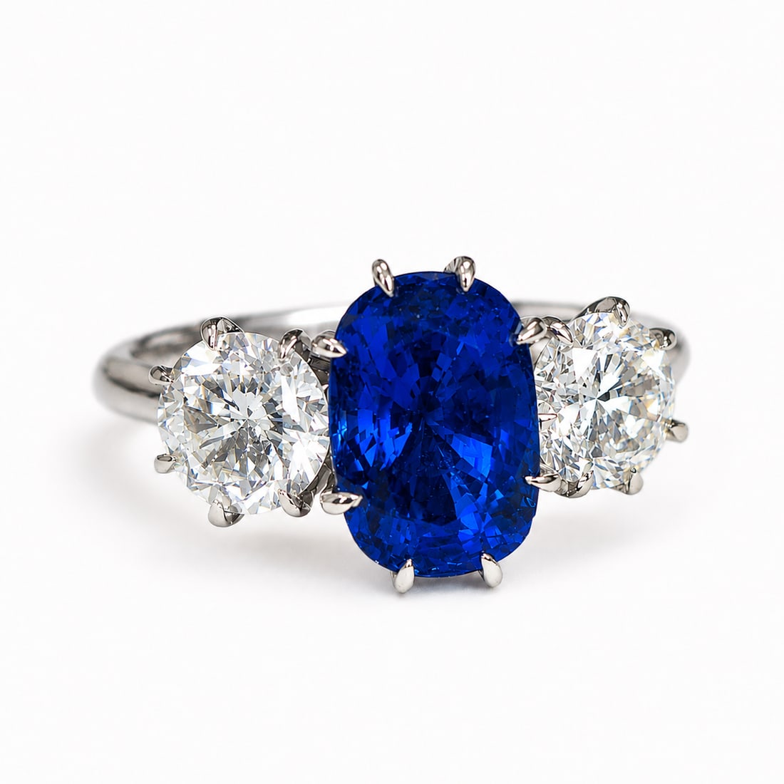SAPPHIRE AND DIAMOND 3-STONE RING,: SAPPHIRE AND DIAMOND 3-STONE RING,3.1 grams, testing 18 ct. gold.Rich and vibrant sapphire of approx. 2.60 ct.Bright and lively diamonds, totalling approx. 1.30 ct.Size L.