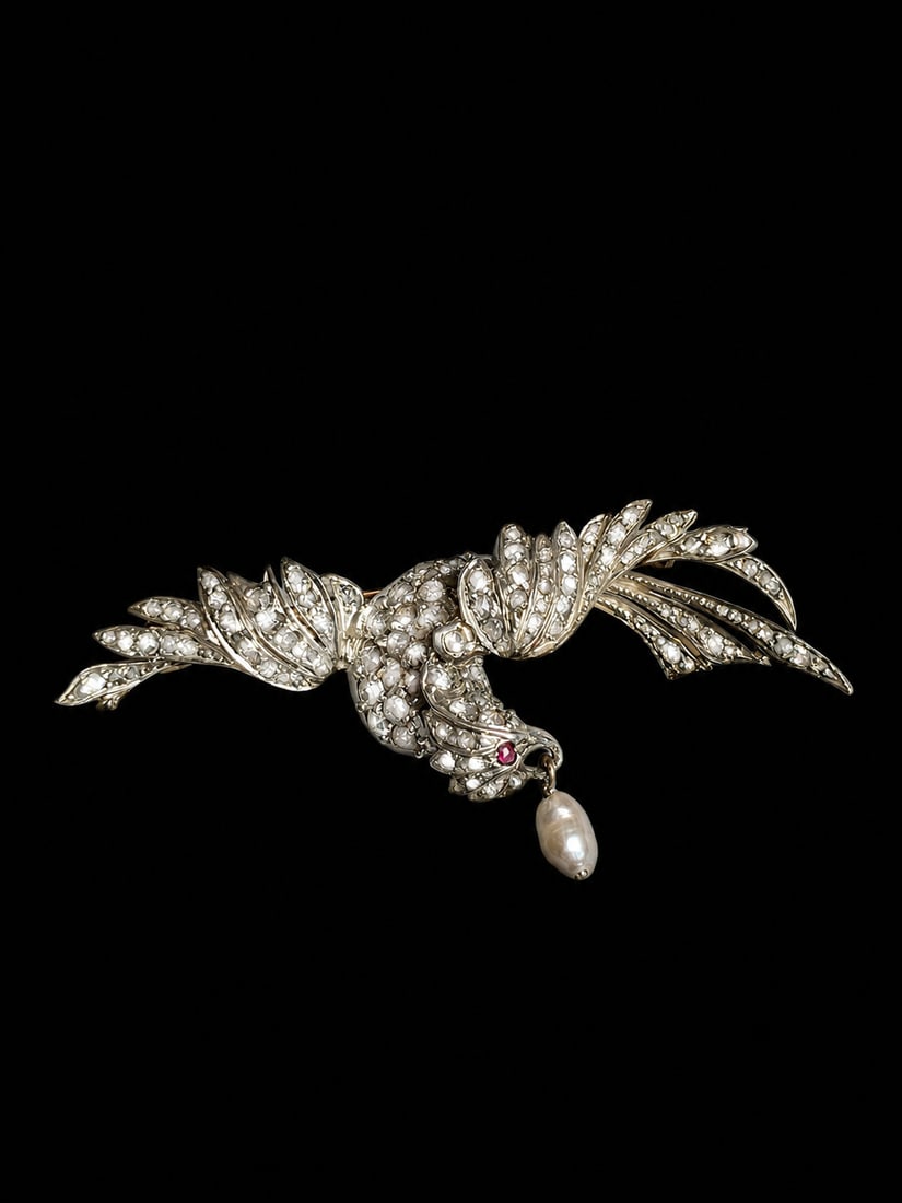 ANTIQUE DIAMOND AND PEARL BIRD OF PRAY BROOCH,: ANTIQUE DIAMOND AND PEARL BIRD OF PRAY BROOCH,7.9 grams.Diamonds bright and lively.Pearl drop from its beak (untested, believed to be natural).Ruby eye.W. 4.8 cm.