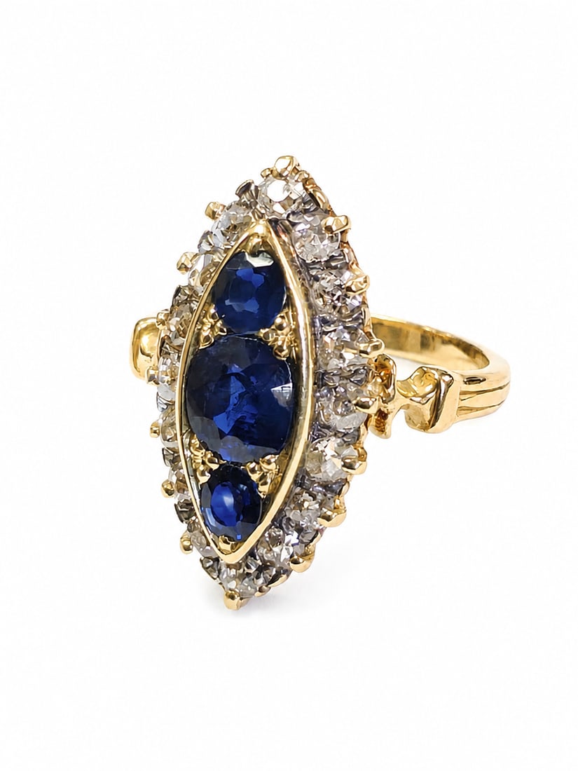 SAPPHIRE AND DIAMOND MARQUISE SHAPED RING,: SAPPHIRE AND DIAMOND MARQUISE SHAPED RING,5,6 grams, testing 18 ct. gold.Rich and vibrant sapphires totalling approx. 1.30 ct.Diamonds bright and lively.Size N.