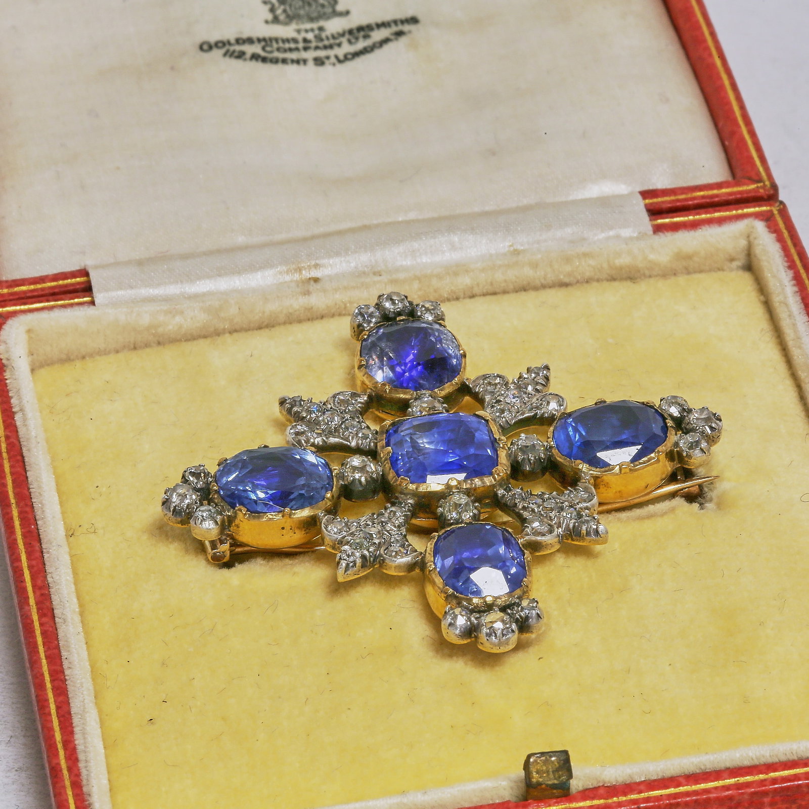 A MAGNIFICENT CERTIFICATED CEYLON NO HEAT VICTORIAN SAPPHIRE AND DIAMOND BROOCH: A MAGNIFICENT CERTIFICATED CEYLON NO HEAT VICTORIAN SAPPHIRE AND DIAMOND BROOCHA magnificent Victorian sapphire and diamond brooch, of cross-shaped design, set with five richly hued cushion-cut sapphi
