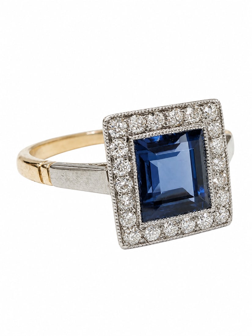 SAPPHIRE AND DIAMOND CLUSTER RING: SAPPHIRE AND DIAMOND CLUSTER RING,3,2 grams, testing 18 ct. gold and platinum.Rich and vibrant sapphire of approx. 1.35 ct.Diamonds bright and lively.Size N.