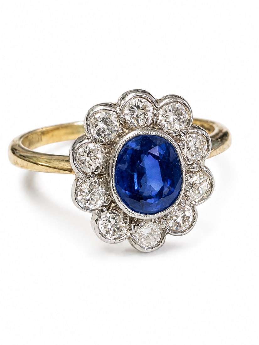 SAPPHIRE AND DIAMOND CLUSTER RING: SAPPHIRE AND DIAMOND CLUSTER RING3.3 grams, marked 18 carat gold. Vibrant sapphire, bright and lively diamonds. Size N.
