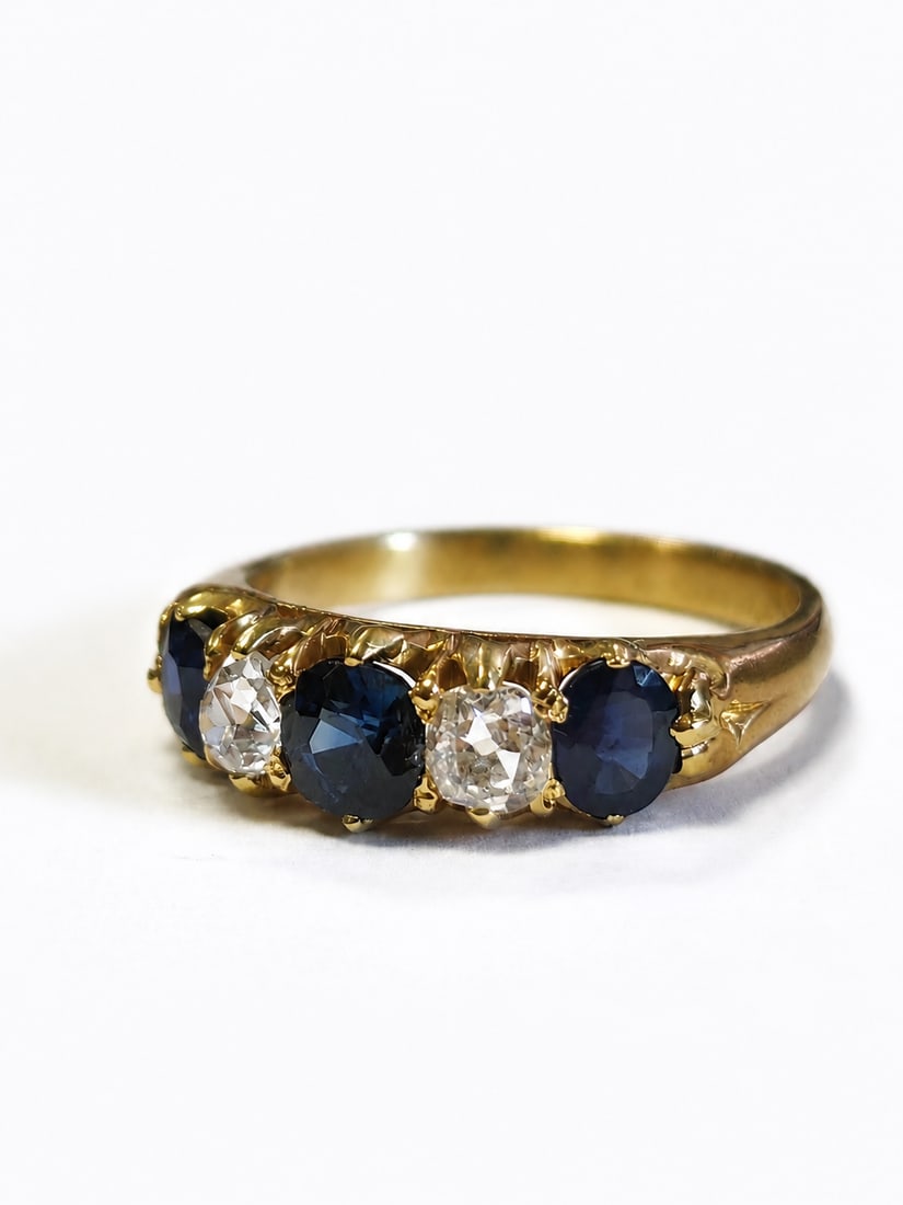 SAPPHIRE AND DIAMOND RING,: SAPPHIRE AND DIAMOND RING,4,5 grams, testing 18 ct. gold.Rich and vibrant sapphires, totalling approx. 1.40 ct.Diamonds bright and lively.Size M.