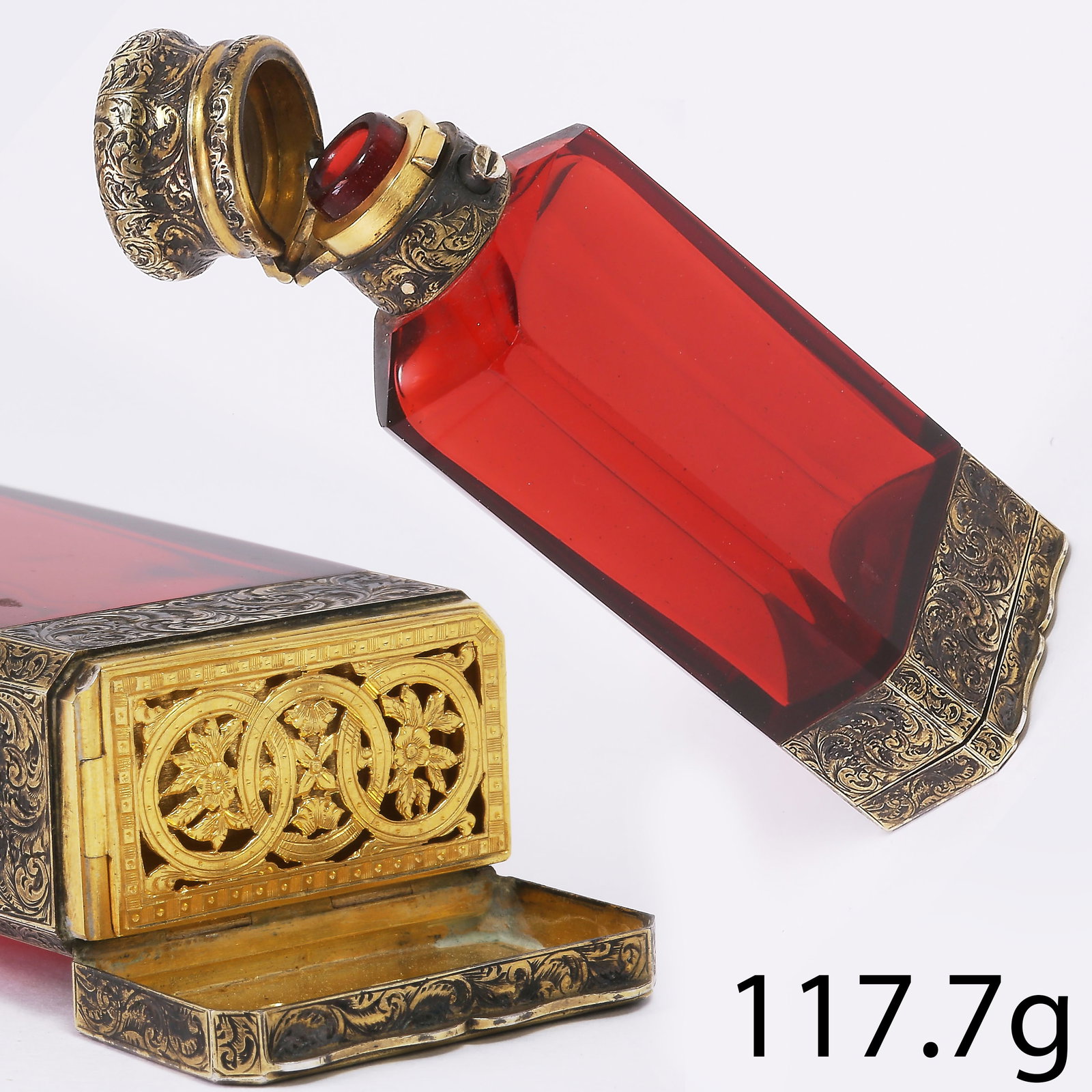 S. MORDAN AND CO. RARE RUBY GLASS PERFUME BOTTLE WITH VINAIGRETTE,: S. MORDAN AND CO. RARE RUBY GLASS PERFUME BOTTLE WITH VINAIGRETTE,117.7 grams.A highly unusual and finely executed Victorian ruby glass perfume bottle. The faceted ruby glass body is of strong, even