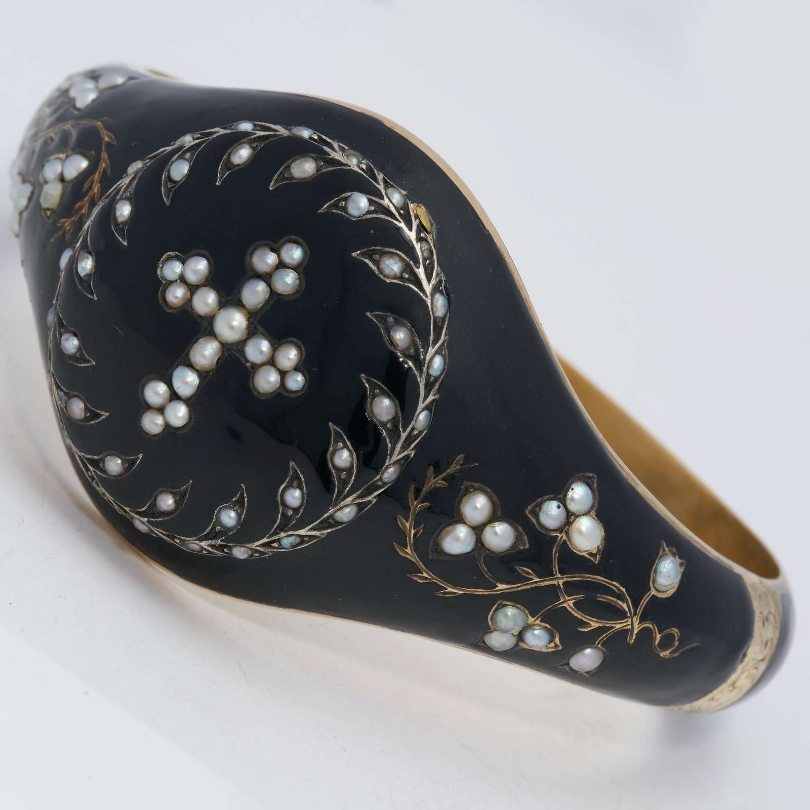 ANTIQUE ENAMEL AND PEARL OPENING HINGED BANGLE: ANTIQUE ENAMEL AND PEARL OPENING HINGED BANGLE 39.9 grams high cart gold The top can open to reveal the hidden compartment.enamel in good condition well matched pearls, not tested in great condition