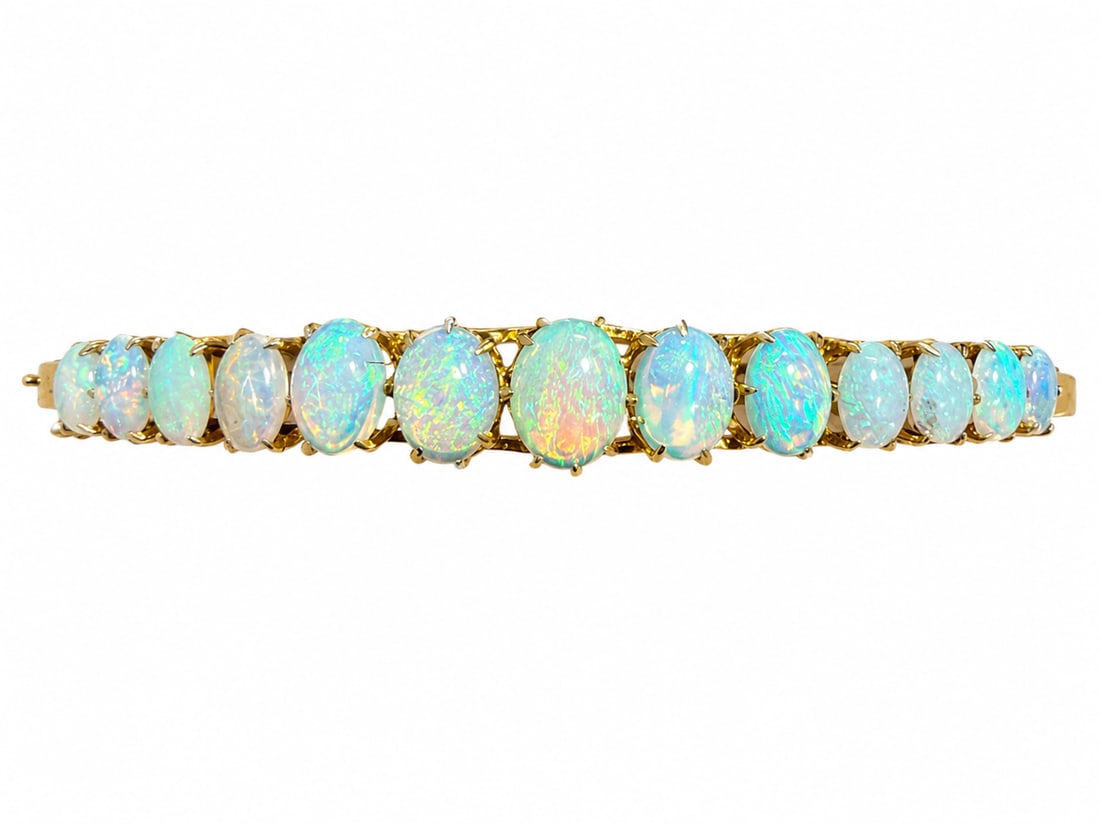 FINE OPAL HINGED GOLD BANGLE,: FINE OPAL HINGED GOLD BANGLE,5,8 grams.Rich and vibrant opals with good play of colour.Inner diam. 5.6 cm.