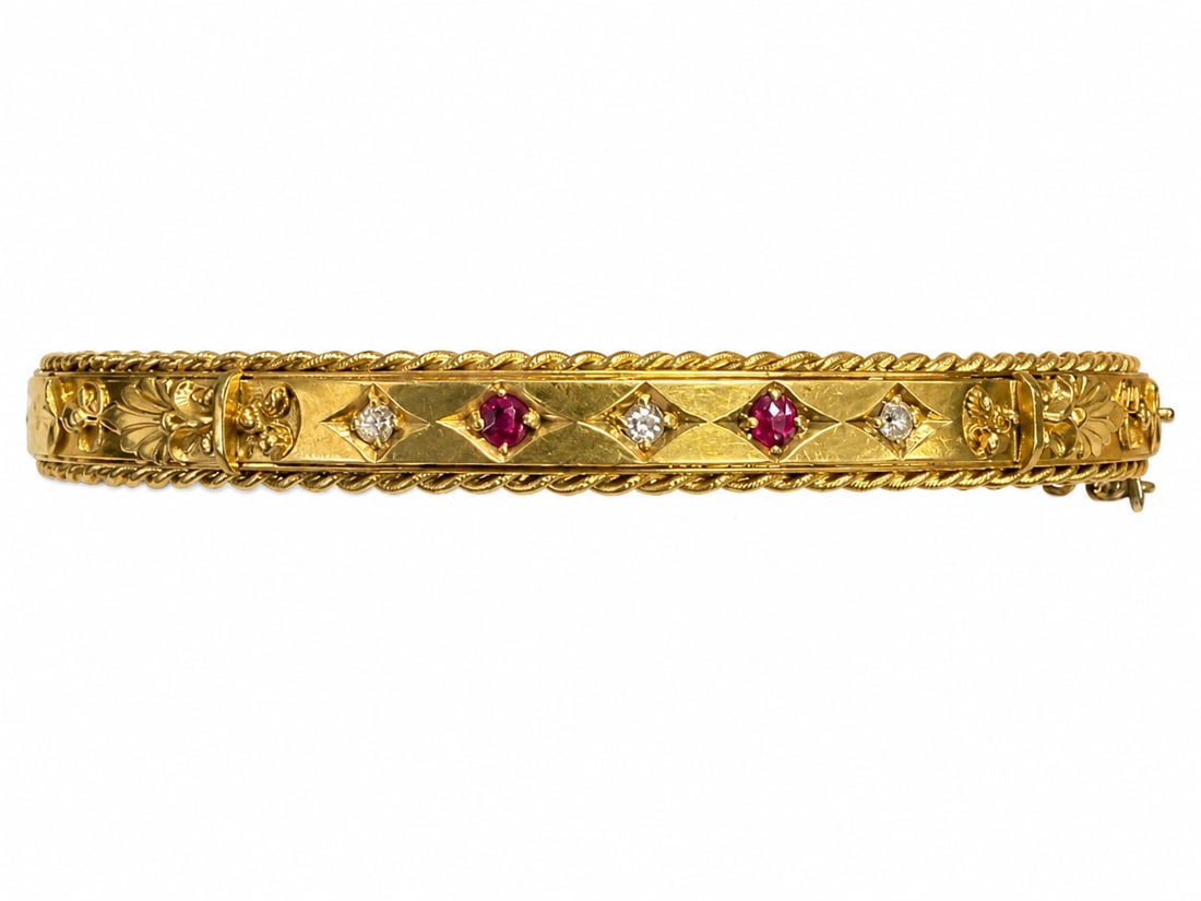 ANTIQUE RUBY AND DIAMOND HINGED BANGLE,: ANTIQUE RUBY AND DIAMOND HINGED BANGLE,10.3 grams, 15 ct. gold.Rich and vibrant rubies.Diamonds bright and lively.Inner diam. 5.8 cm.