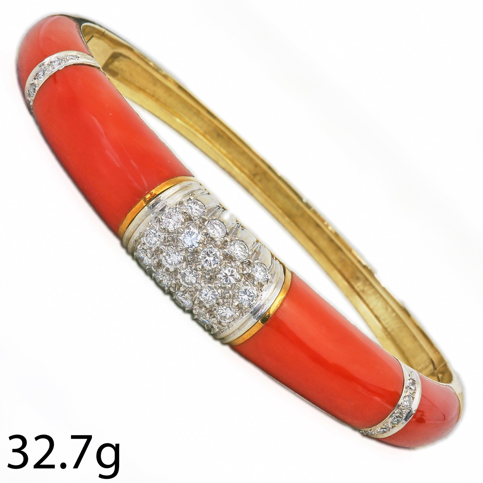 CORAL AND DIAMOND BANGLE,: CORAL AND DIAMOND BANGLE,37.2 grams, 18 ct. gold.Diamonds bright and lively.Fine coral, well matched.Inner diam. 5.6 cm.