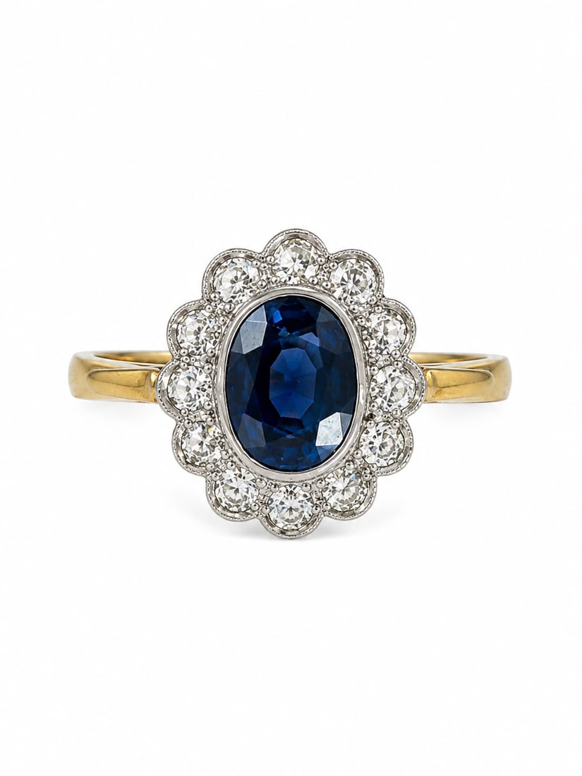SAPPHIRE AND DIAMOND CLUSTER RING: SAPPHIRE AND DIAMOND CLUSTER RING,4,8 grams, 18 ct. gold.Rich and vibrant sapphire of approx. 1.90 ct.Diamonds bright and lively.Size L.