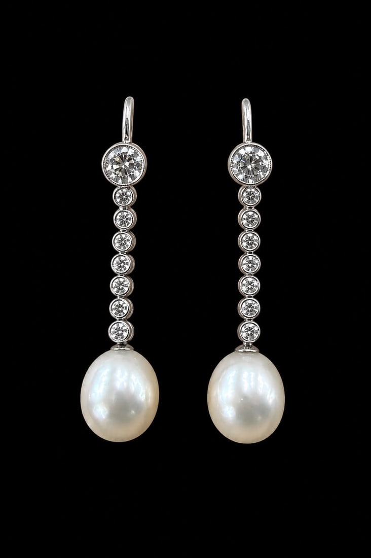 PAIR OF CERTIFICATED NATURAL SALTWATER PEARL AND DIAMOND EARRINGS: PAIR OF CERTIFICATED NATURAL SALTWATER PEARL AND DIAMOND EARRINGS,5.1 grams, testing high carat gold.Each line of diamonds suspending a fine pearl of approx. 10.37 x 8.57 x 8.08 and 10.21 x 8.69 x 7.8