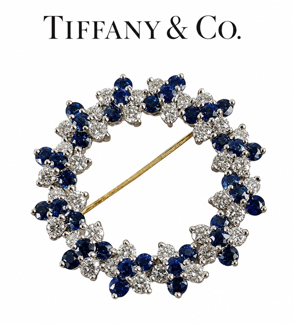 TIFFANY & CO SAPPHIRE AND DIAMOND BROOCH: TIFFANY & CO SAPPHIRE AND DIAMOND BROOCH 12.5 grams platinum signed tiffany& co, makers mark rich vibrant matching sapphiresbright lively diamonds aprrox 4.50 ct of gems 3.2 cm diameter in excellent c