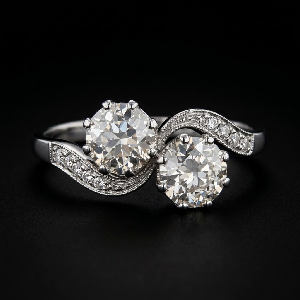 DIAMOND TOI-ET-MOI TWIST RING: DIAMOND TOI-ET-MOI TWIST RING, 3.8 grams, testing platinum.Bright and lively diamonds, totalling approx. 1.20 ct.Size N.