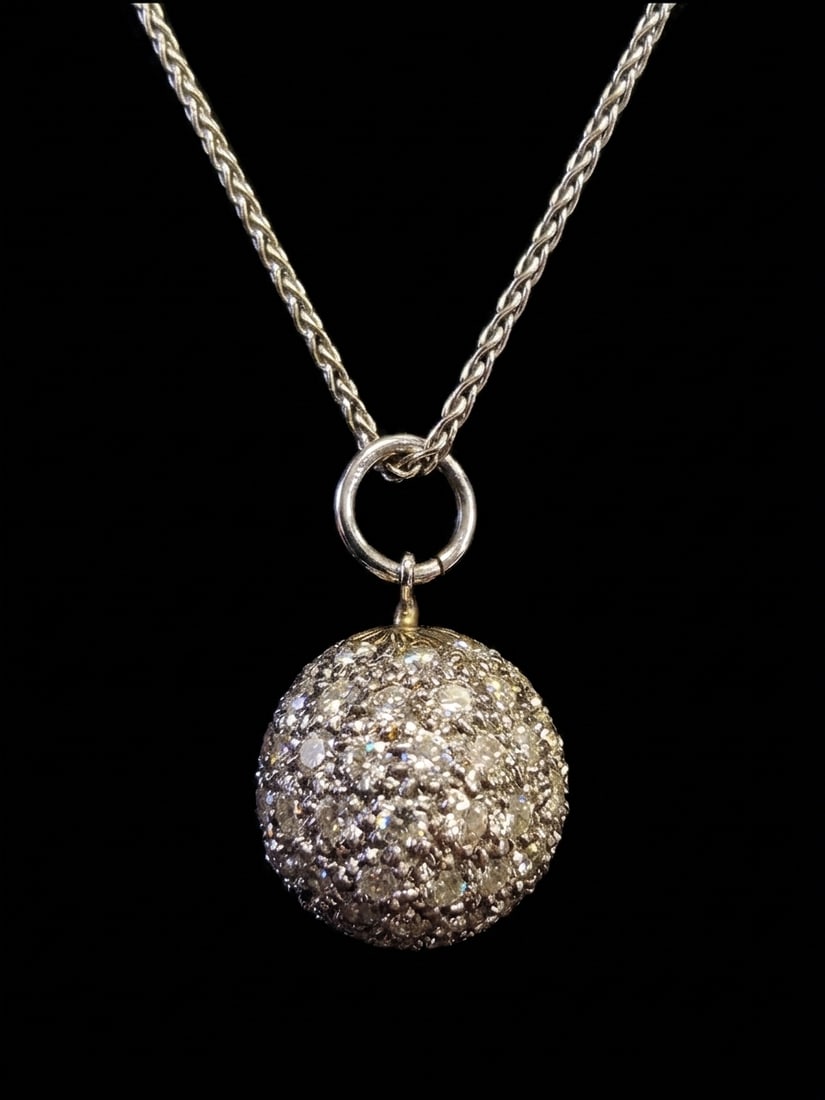 DIAMOND BALL PENDANT AND CHAIN NECKLACE: DIAMOND BALL PENDANT AND CHAIN NECKLACE,6,6 grams, testing 14 ct. gold.Diamonds bright and lively.L. pendant 1.9 cm.