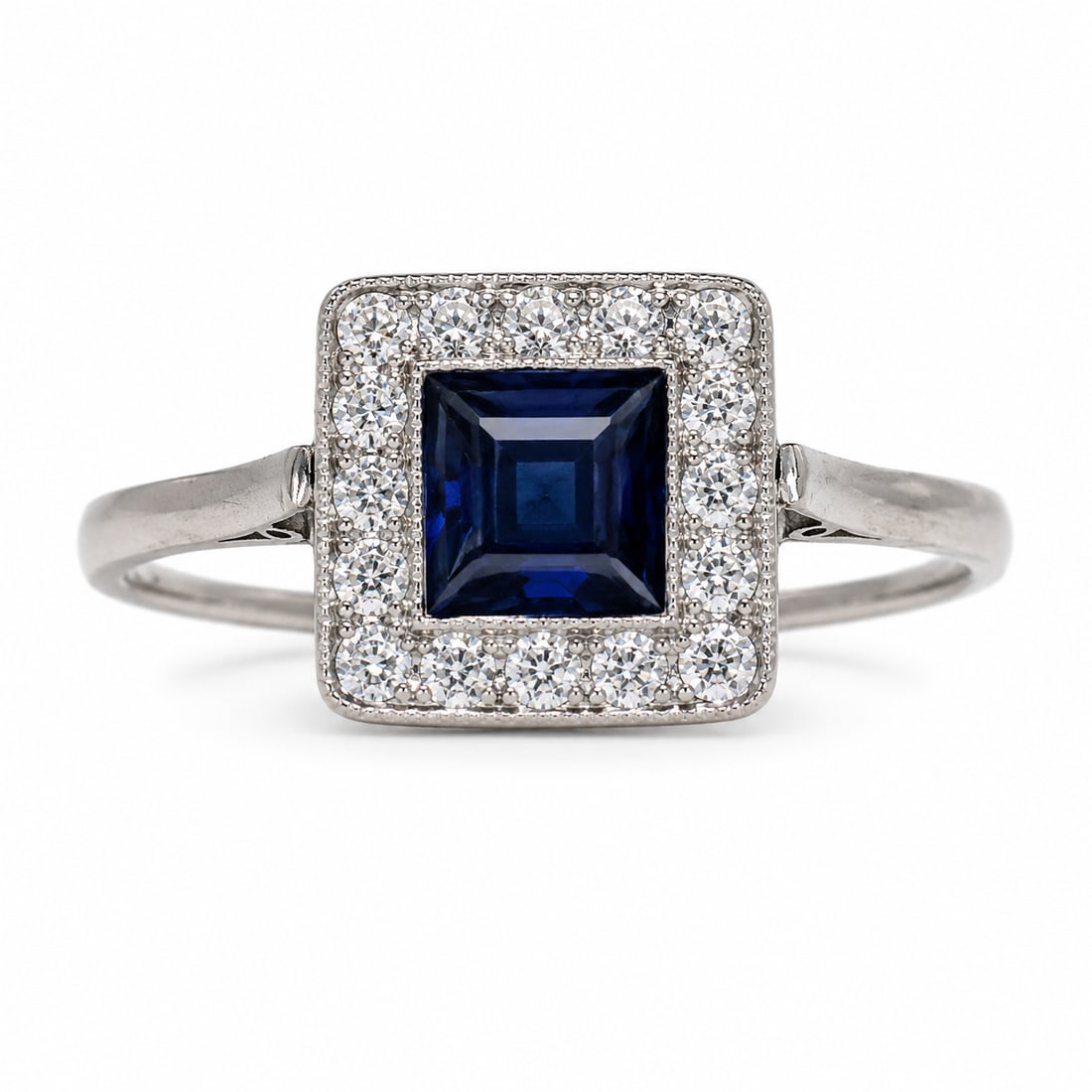 SAPPHIRE AND DIDMAOND CLUSTER RING: SAPPHIRE AND DIDMAOND CLUSTER RING,3,4 grams, testing platinum.Rich and vibrant sapphire of approx. 1.10 ct.Diamonds bright and lively.Size N.