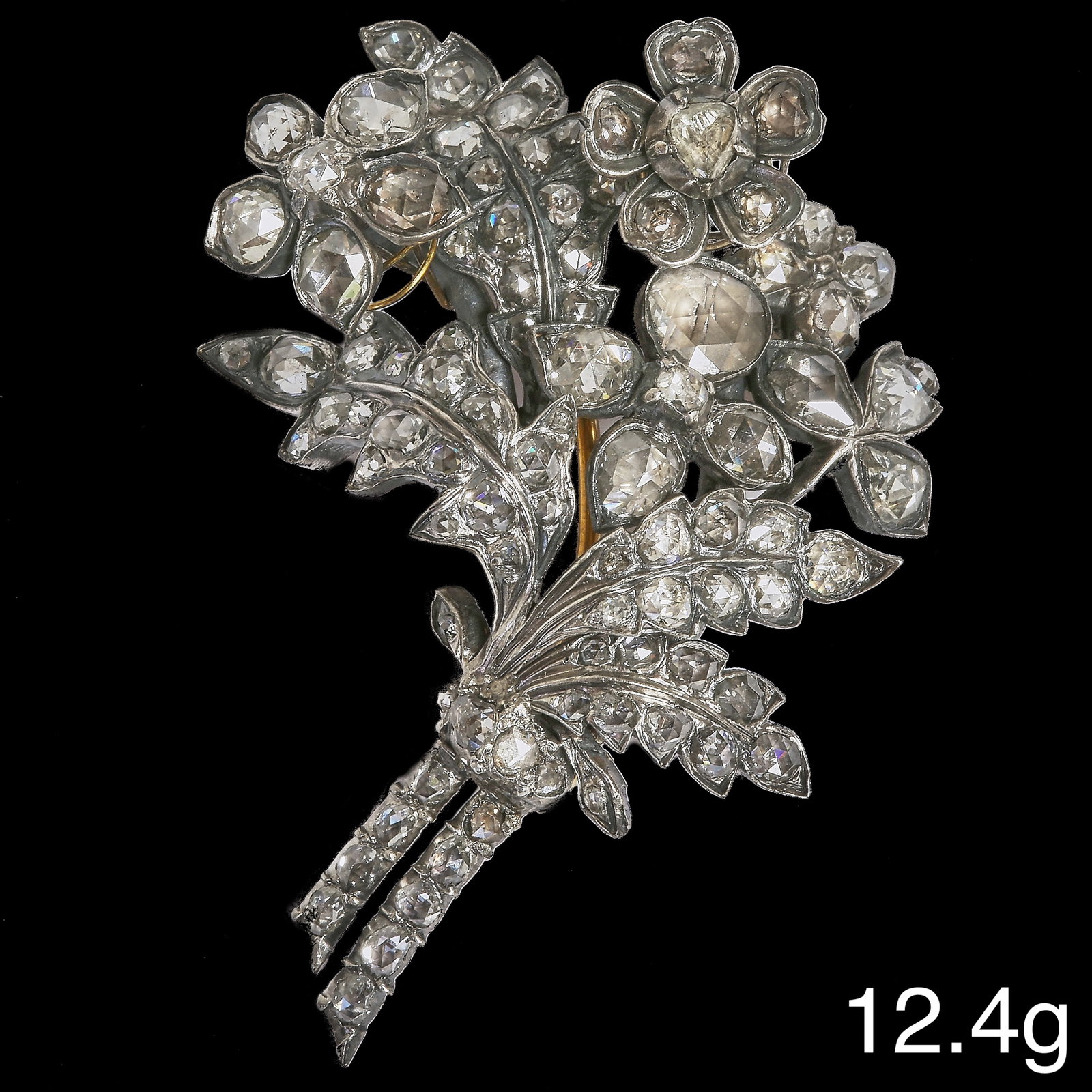 VICTORIAN EN TREMBLANT DIAMOND FLORAL SPRAY BROOCH: VICTORIAN EN TREMBLANT DIAMOND FLORAL SPRAY BROOCH12.4 grams, testing high carat gold and silver. Comprising approx. 3.50 ct of diamonds.The two upper flowers set en tremblant.L. 5 cm.