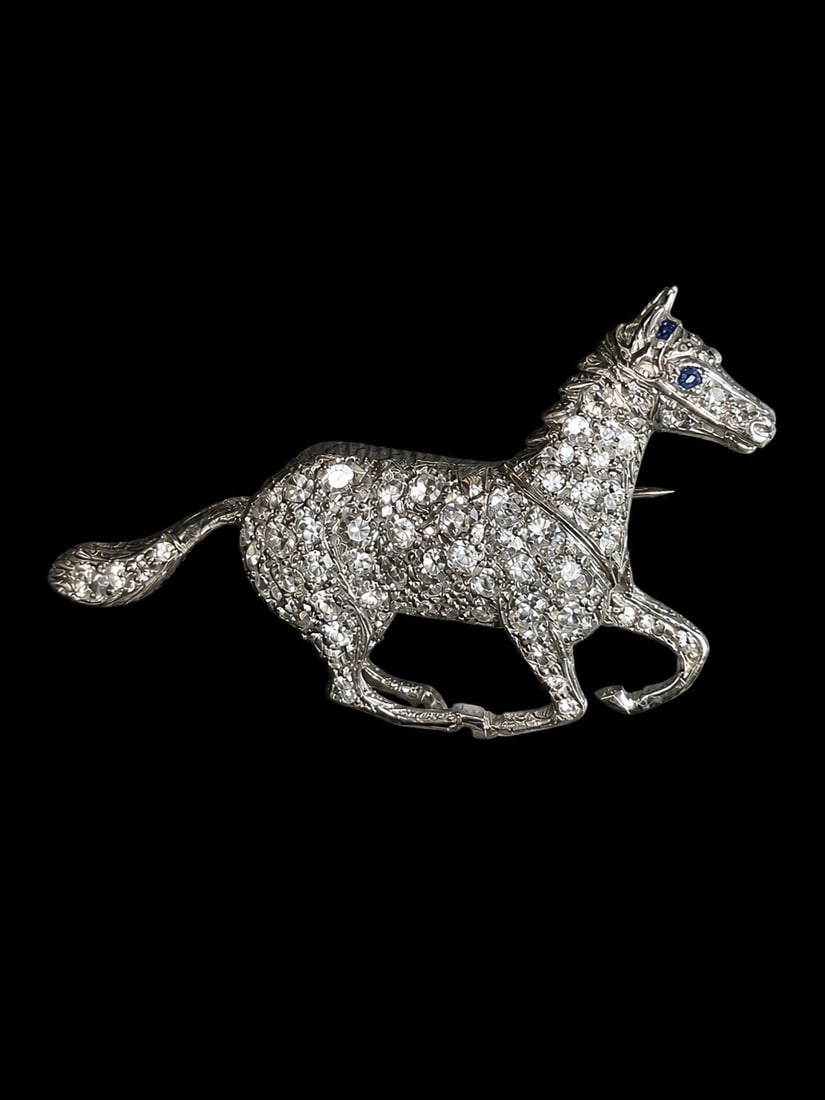 DIAMOND HORSE BROOCH: DIAMOND HORSE BROOCH,7 grams, testing platinum.Bright and lively diamonds, totalling approx. 1.20 ct.Well detailed.W. 3.9 cm.