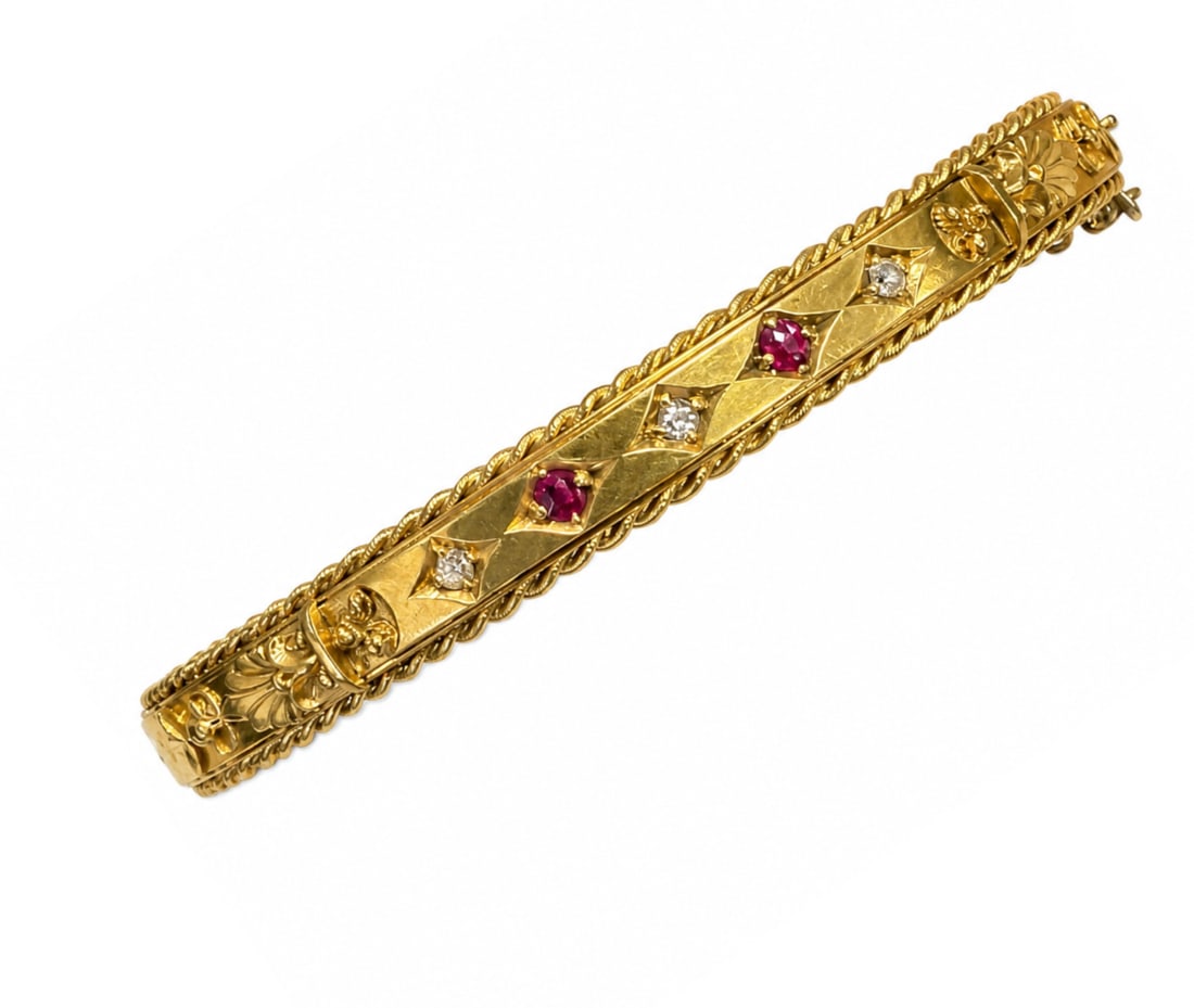 ANTIQUE RUBY AND DIAMOND HINGED BANGLE: ANTIQUE RUBY AND DIAMOND HINGED BANGLE,10.3 grams, 15 ct. gold.Rich and vibrant rubies.Diamonds bright and lively.Inner diam. 5.8 cm.