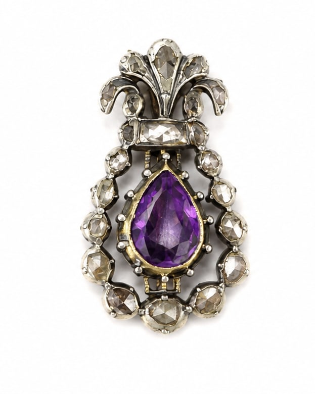 ANTIQUE AMETHYST AND DIAMOND BROOCH: ANTIQUE AMETHYST AND DIAMOND BROOCH,5,6 grams, gold backed.Of stylized floral design.Rich and vibrant amethyst.Diamonds bright and lively.L. 3.7 cm.