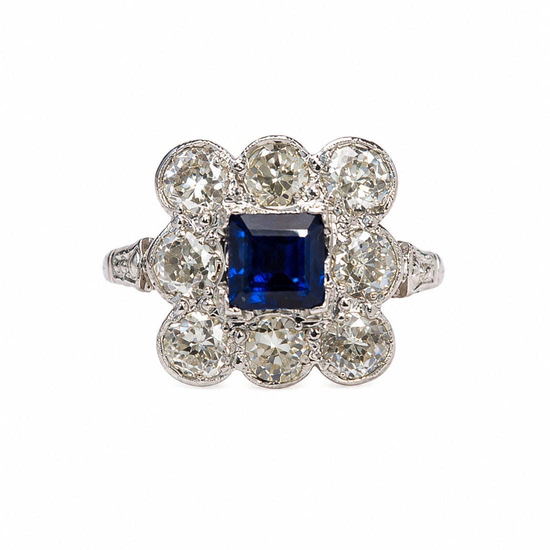 SAPPHIRE AND DIAMOND CLUSTER RING: SAPPHIRE AND DIAMOND CLUSTER RING,4,6 grams, 18 ct. gold and platinum.Vibrant sapphire of approx. 0.80 ct.Diamonds bright and lively totalling approx. 1.80 ct.Size N 1/2.