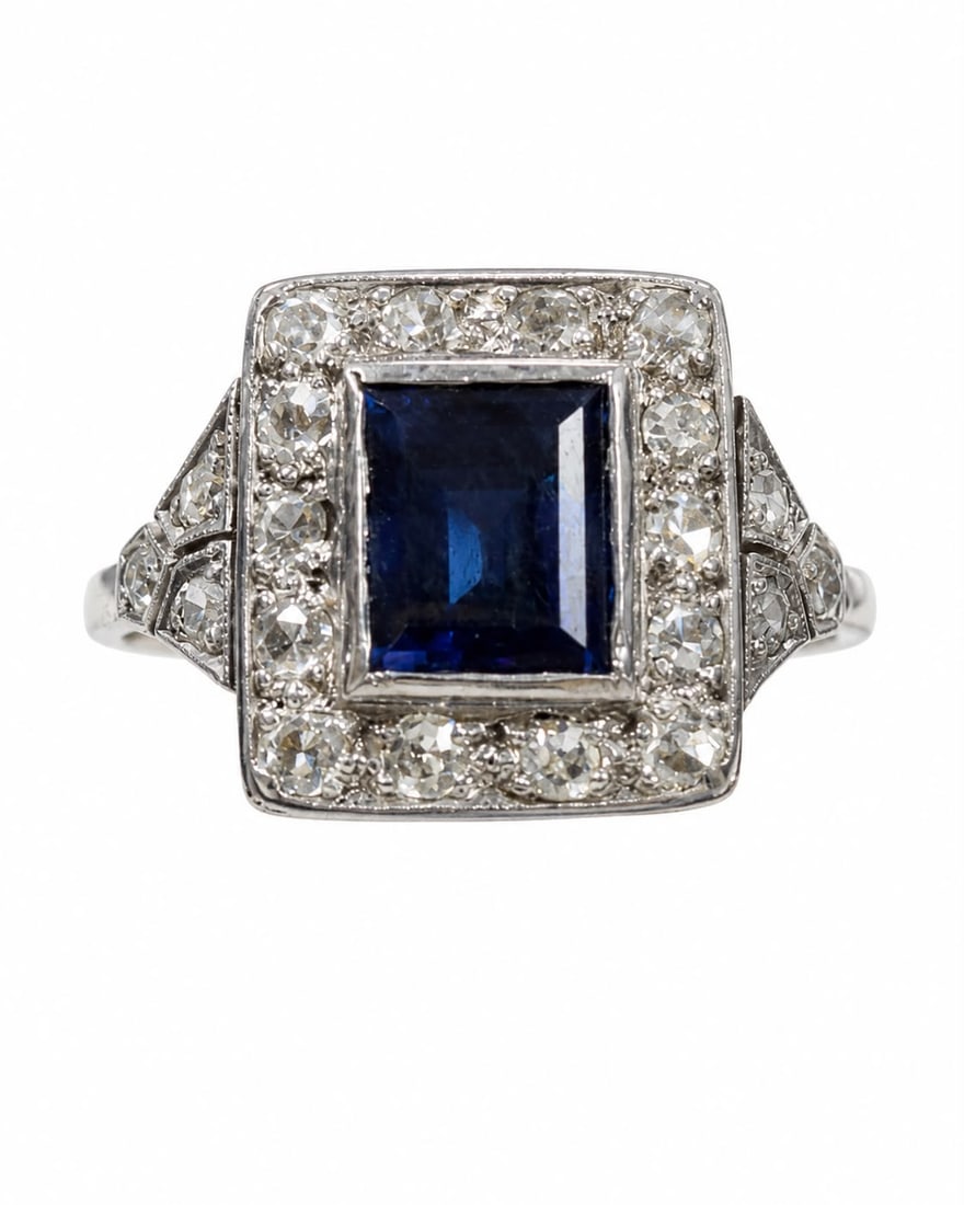 SAPPHIRE AND DIAMOND CLUSTER RING: SAPPHIRE AND DIAMOND CLUSTER RING,3,4 grams, testing platinum.Rich and vibrant sapphire of approx. 1.10 ct.Diamonds bright and lively.Size N.